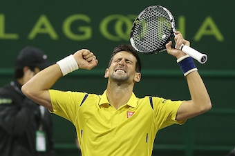 Novak Djokovic of Serbia celebrates after beating Rafael Nadal of Spain in the final of the Qatar Open tennis tournament on January 9, 2016, in Doha. Djokovic won his 60th ATP title with his crushing 6-1, 6-2 triumph over Rafael Nadal in the Qatar Open fi