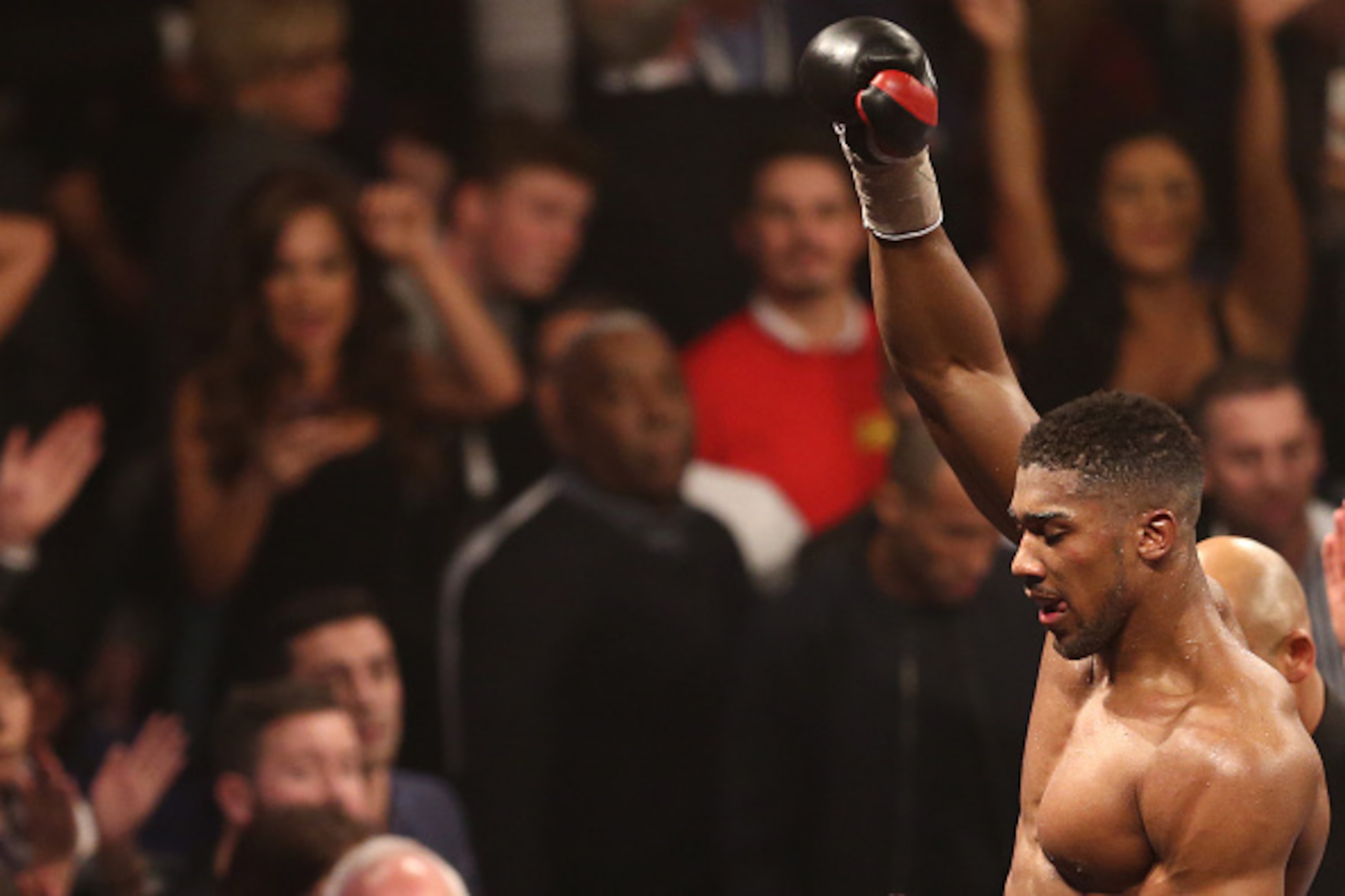 British boxer Anthony Joshua (L) celebrates beating British boxer Dillian Whyte in the British and Commonwealth heavyweight title boxing match at the O2 arena in London on December 12, 2015. AFP PHOTO / JUSTIN TALLIS / AFP / JUSTIN TALLIS        (Photo cr
