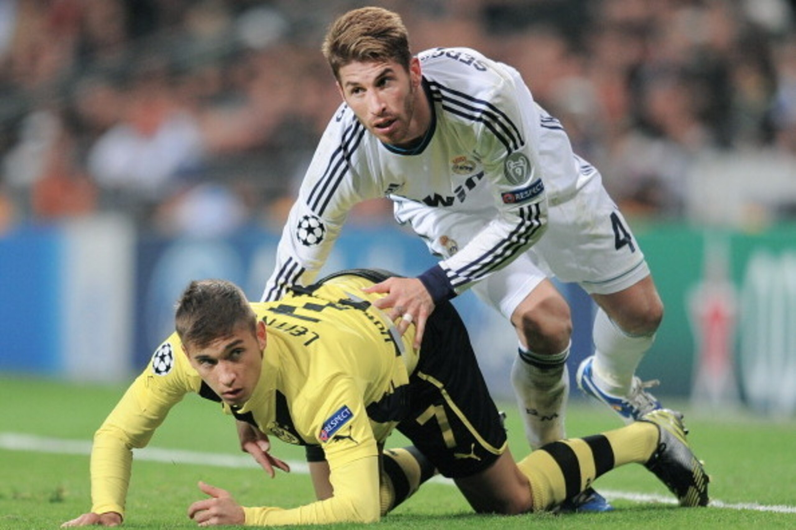 MADRID, SPAIN - NOVEMBER 06: Sergio Ramos (R) of Real Madrid falls over Moritz Leitner of Borussia Dortmund during the UEFA Champions League Group D match between Real Madrid and Borussia Dortmund at Estadio Santiago Bernabeu on November 6, 2012 in Madrid