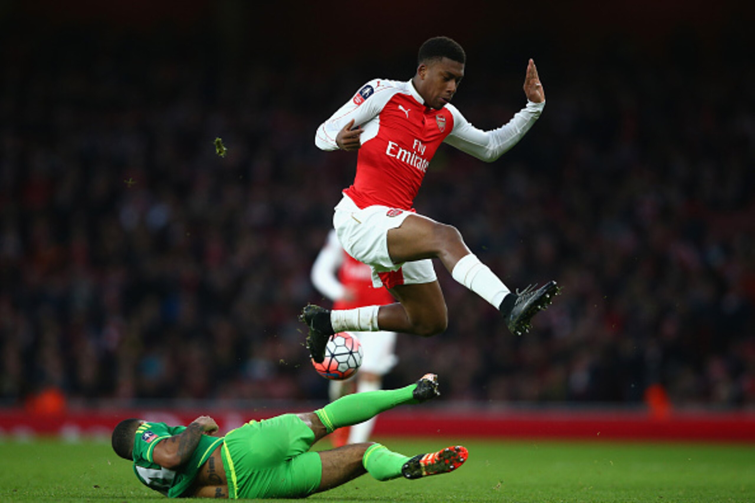 LONDON, ENGLAND - JANUARY 09:  Alex Iwobi of Arsenal being tackled by Deandre Yedlin during the Emirates FA Cup Third Round match bewtween Arsenal and Sunderland at Emirates Stadium on January 9, 2016 in London, England.  (Photo by Paul Gilham/Getty Image