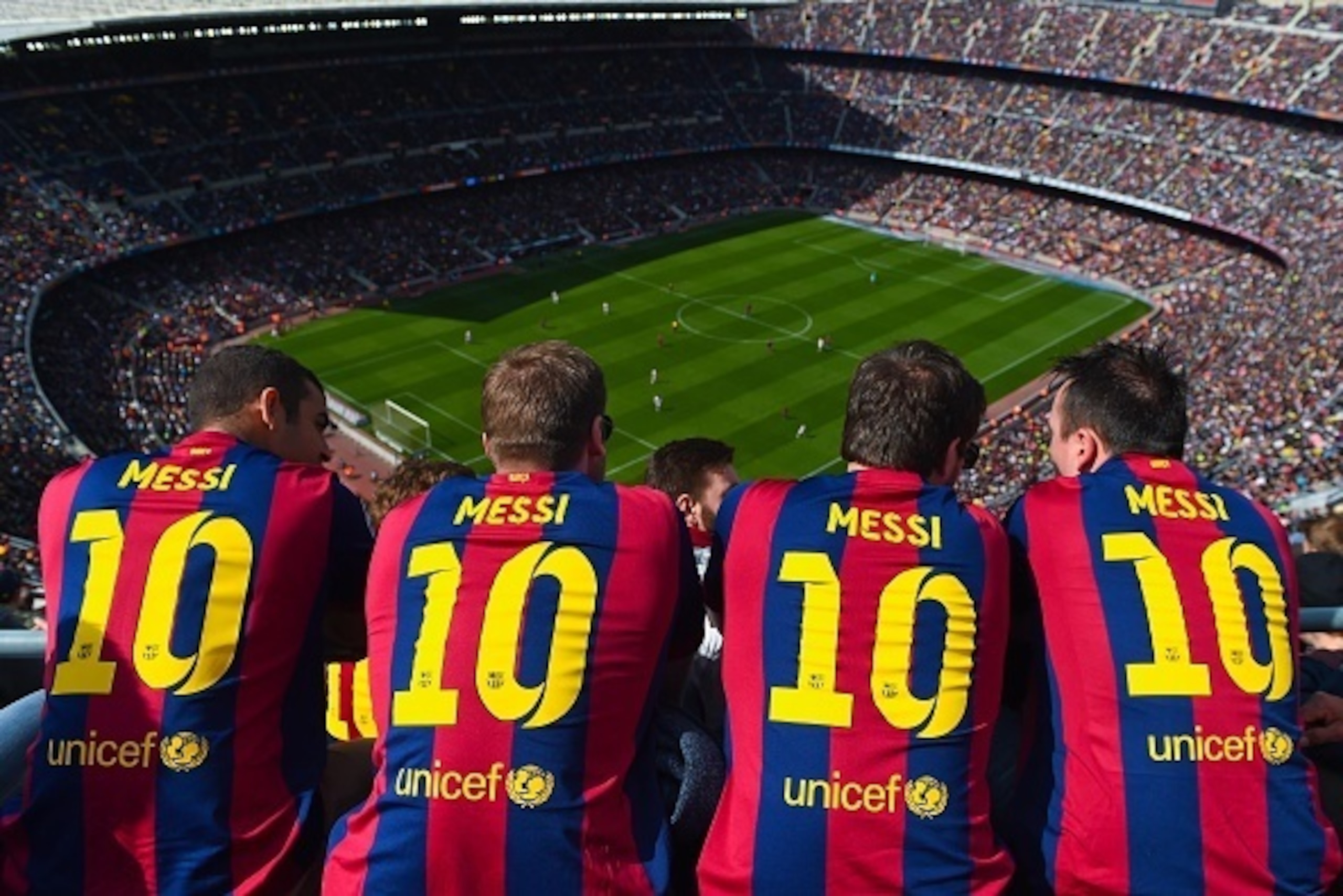 BARCELONA, SPAIN - MARCH 08: FC Barcelona supporters wearing Lionel Messi shirts watch the game from the stands during the La Liga match between FC Barcelona and Rayo Vallecano de Madrid at Camp Nou on March 8, 2015 in Barcelona, Spain.  (Photo by David R