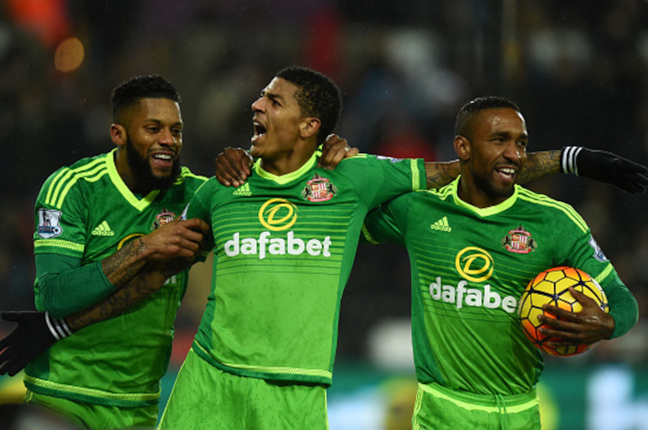 SWANSEA, WALES - JANUARY 13:   Patrick van Aanholt (C) of Sunderland celebrates scoring his team's second goal with his team mates Jeremain Lens (L) and Jermain Defoe (R during the Barclays Premier League match between Swansea City and Sunderland at Liber