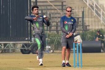 Pakistan cricket batting coach Grant Flower (R) watches as bowler Mohammad Amir delivers a ball during a team practice session at a camp ahead of the New Zealand tour, in Lahore on January 2, 2016. Paceman Mohammad Amir, who served a prison term for spot-