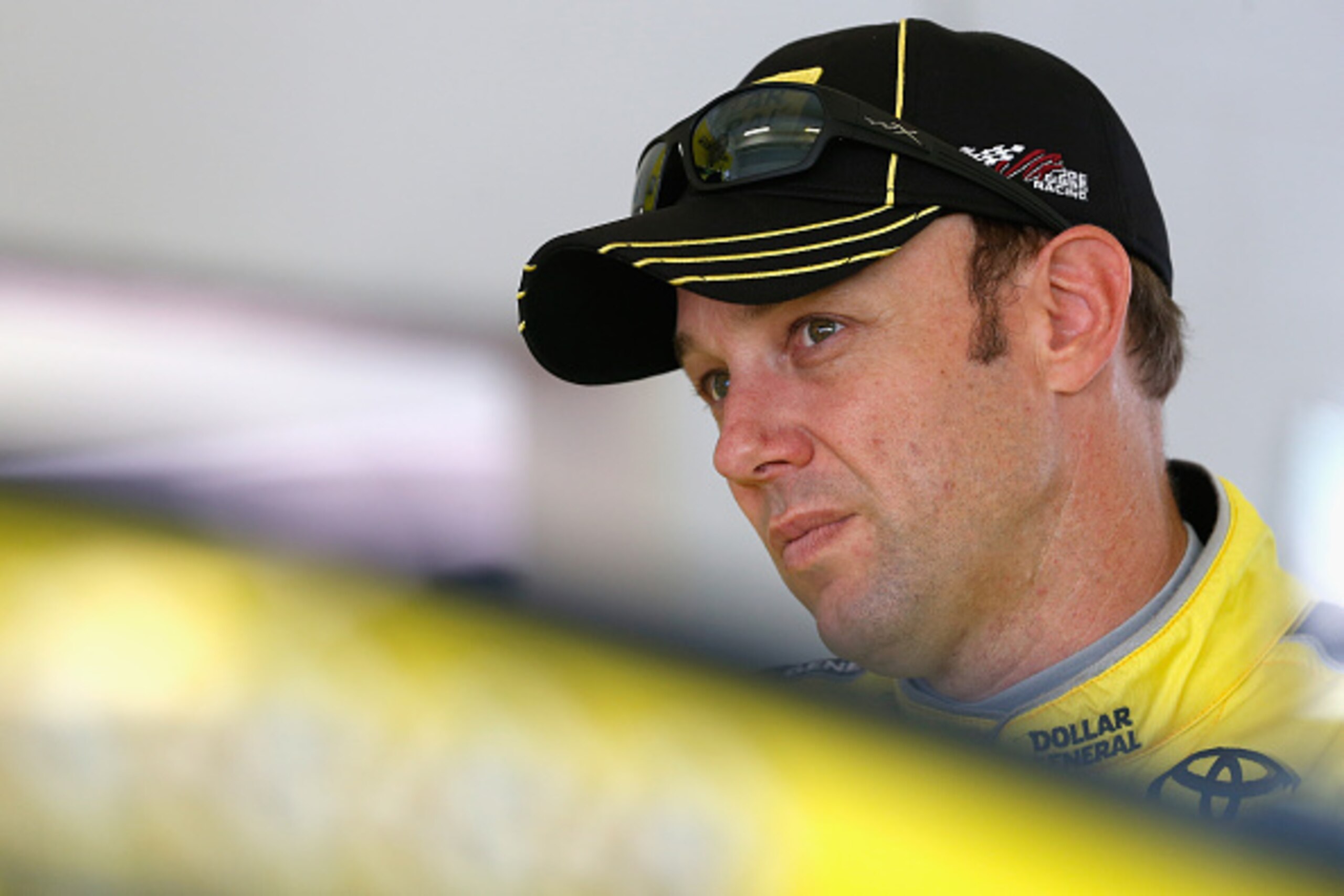 HOMESTEAD, FL - NOVEMBER 20:  Matt Kenseth, driver of the #20 Dollar General Toyota, stands in the garage area during practice for the NASCAR Sprint Cup Series Ford EcoBoost 400 at Homestead-Miami Speedway on November 20, 2015 in Homestead, Florida.  (Pho