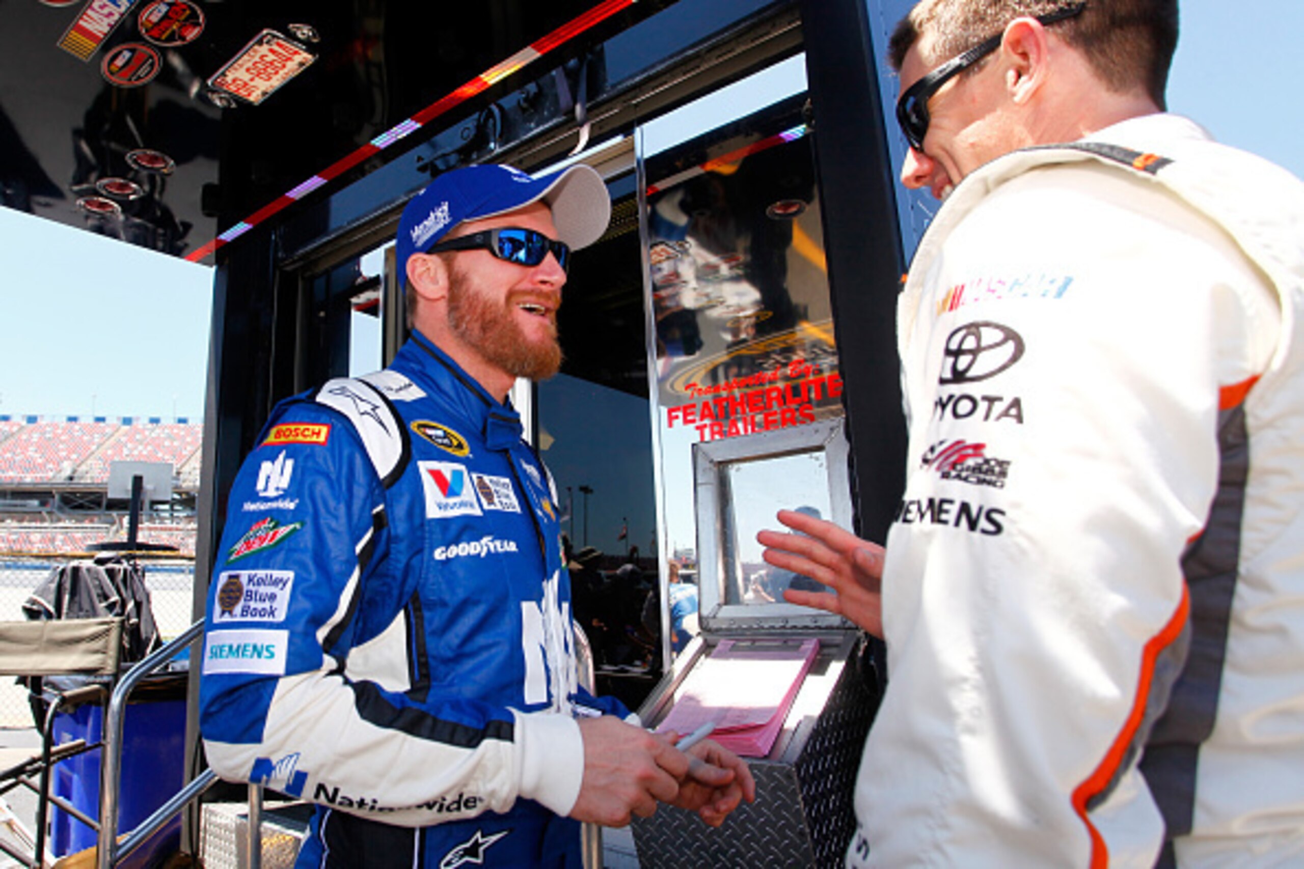 TALLADEGA, AL - MAY 01:  Dale Earnhardt Jr., driver of the #88 Nationwide Chevrolet, talks to Carl Edwards, driver of the #19 ARRIS Toyota, in the garage area during practice for the NASCAR Sprint Cup Series GEICO 500 at Talladega Superspeedway on May 1, 
