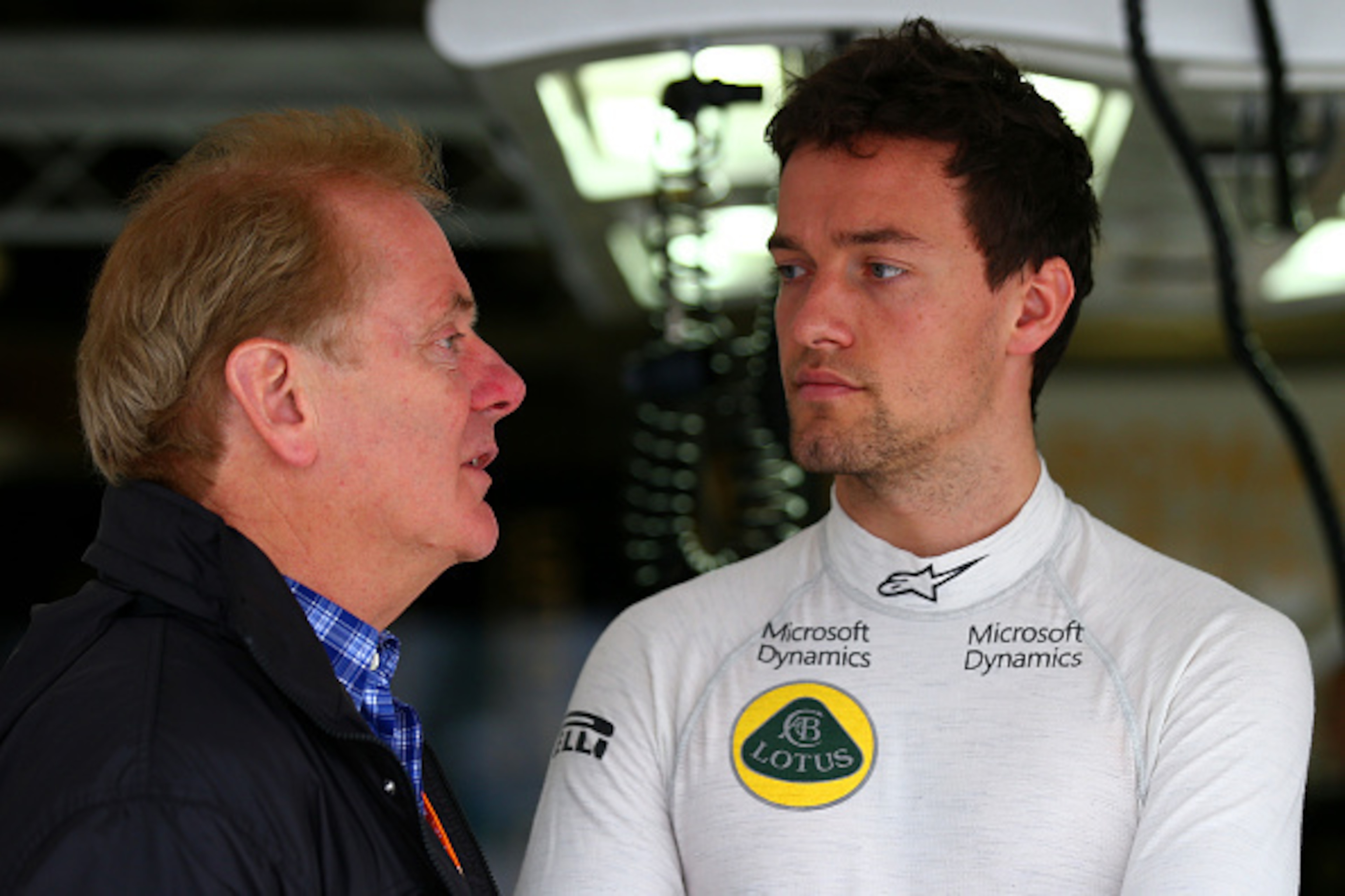 SUZUKA, JAPAN - SEPTEMBER 25:  Jolyon Palmer of Great Britain and Lotus speaks with his father Jonathan Palmer outside the team garage during practice for the Formula One Grand Prix of Japan at Suzuka Circuit on September 25, 2015 in Suzuka.  (Photo by Ma