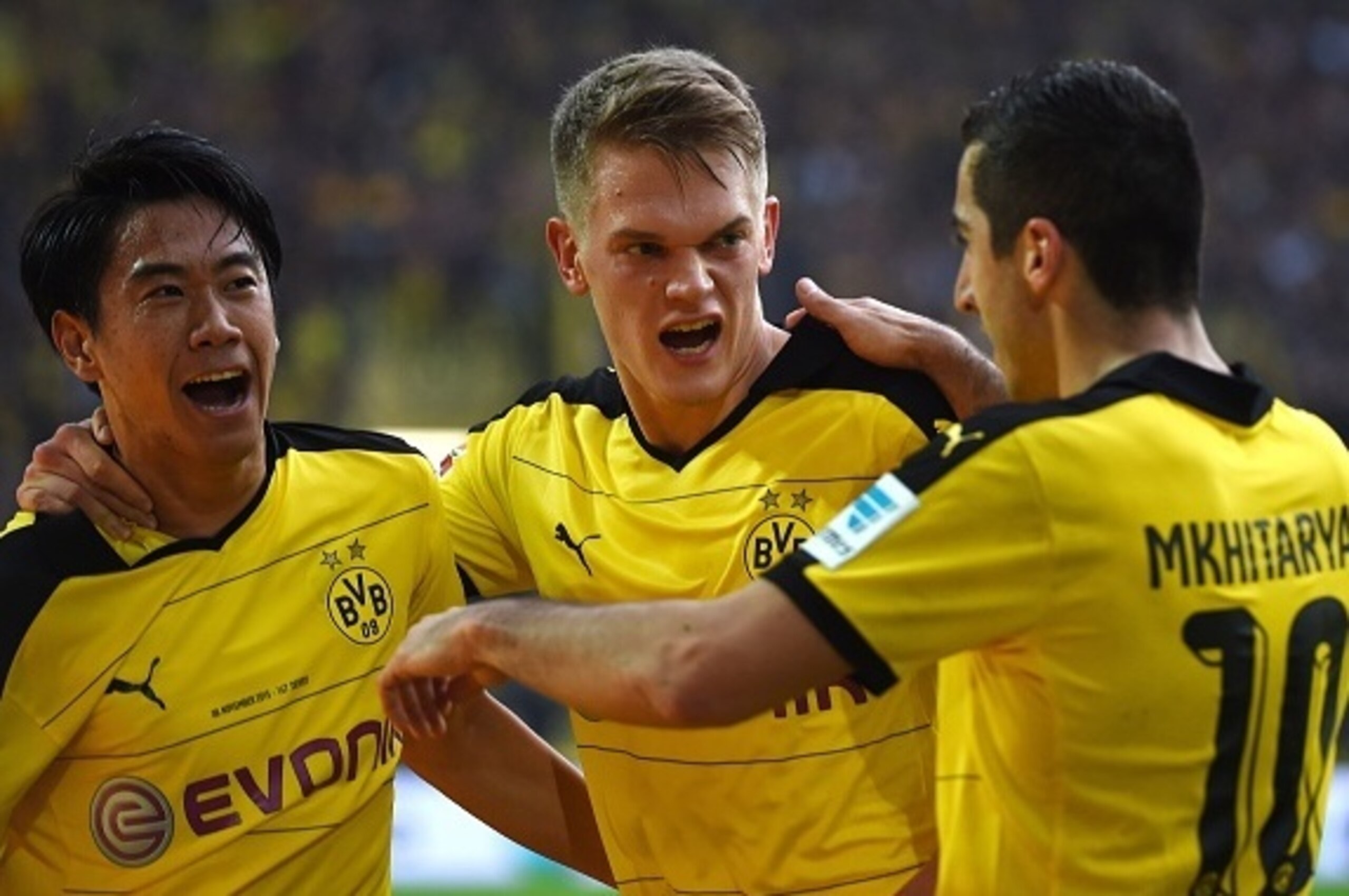 Dortmund's Japanese midfielder Shinji Kagawa, Dortmund's defender Matthias Ginter and Dortmund's Armenian midfielder Henrikh Mkhitaryan celebrate scoring during the German first division football Bundesliga match Borussia Dortmund vs FC Schalke 04 on Nove