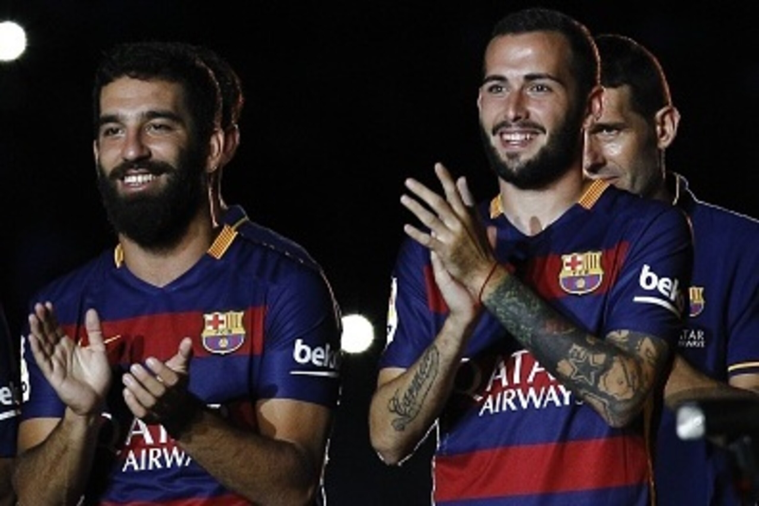 Barcelona's Turkish midfielder Arda Turan (L) and Barcelona's defender Aleix Vidal (R) stand during an official team presentation at the 50th Joan Gamper Trophy football match FC Barcelona vs AS Roma at the Camp Nou stadium in Barcelona on August 5, 2015.