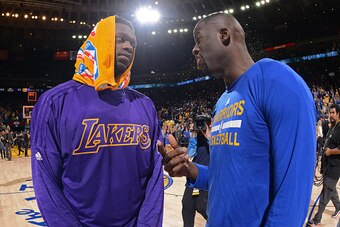 OAKLAND, CA - NOVEMBER 24:  Julius Randle #30 of the Los Angeles Lakers talks to Draymond Green #23 of the Golden State Warriors after the game on November 24, 2015 at ORACLE Arena in Oakland, California. NOTE TO USER: User expressly acknowledges and agre