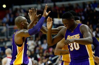 WASHINGTON, DC - DECEMBER 02: Kobe Bryant #24 of the Los Angeles Lakers celebrates with Julius Randle #30 during a timeout in the second half against the Washington Wizards at Verizon Center on December 2, 2015 in Washington, DC.  NOTE TO USER: User expre
