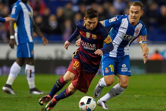 Barcelona's Argentinian forward Lionel Messi (L) vies with Espanyol's midfielder Abraham Gonzalez (R) during the Spanish Copa del Rey (King's Cup) round of 16 second leg football match RCD Espanyol vs FC Barcelona at Cornella-El Prat stadium in Cornella n