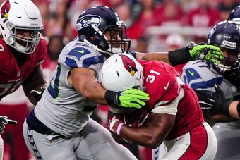 Jan 3, 2016; Glendale, AZ, USA; Arizona Cardinals running back David Johnson (31) is stopped by Seattle Seahawks outside linebacker K.J. Wright (50) during the first half at University of Phoenix Stadium. Mandatory Credit: Matt Kartozian-USA TODAY Sports