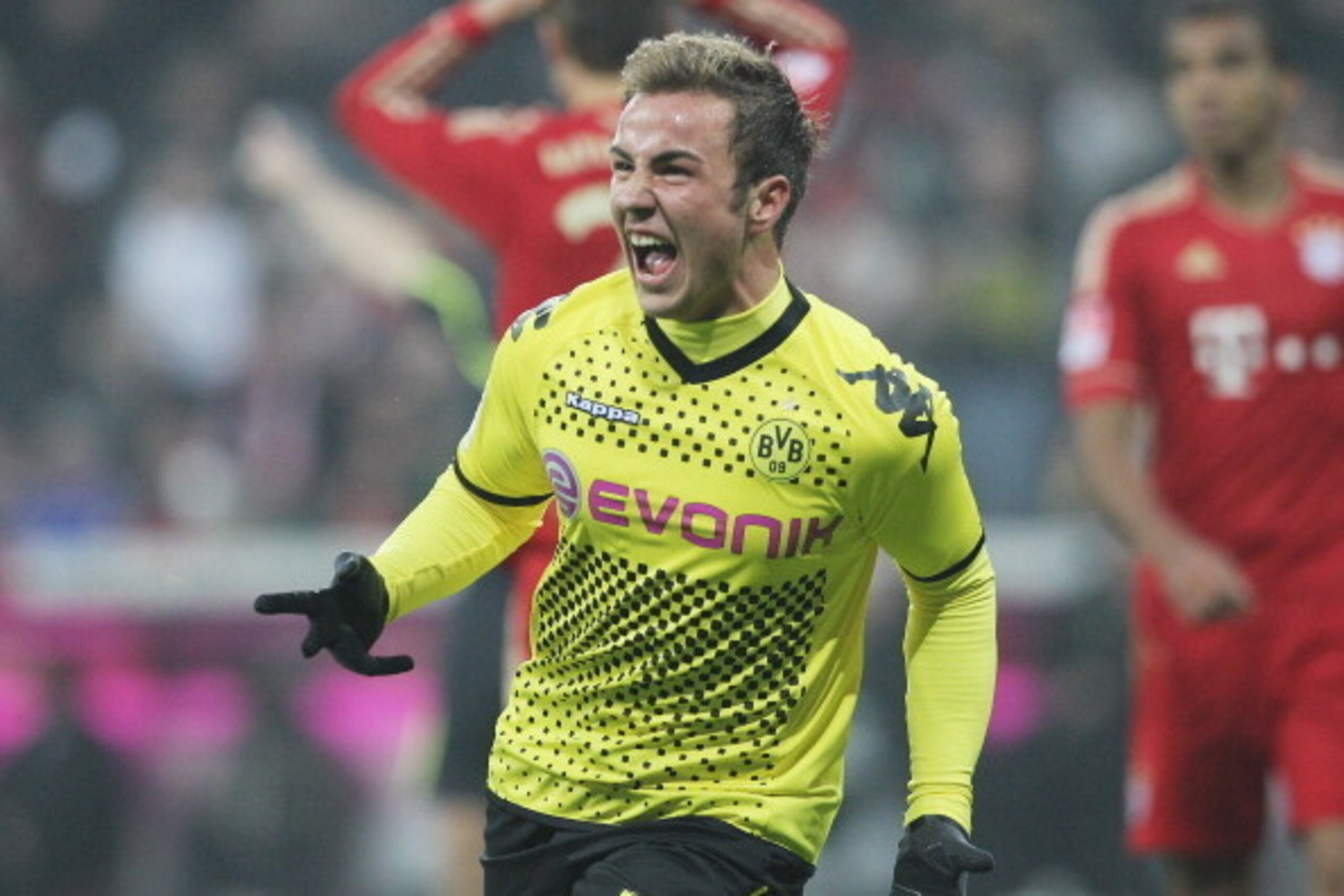MUNICH, GERMANY - NOVEMBER 19:  Mario Goetze of Dortmund celebrates scoring the opening goal during the Bundesliga match between FC Bayern Muenchen and Borussia Dortmund at Allianz Arena on November 19, 2011 in Munich, Germany.  (Photo by Boris Streubel/G