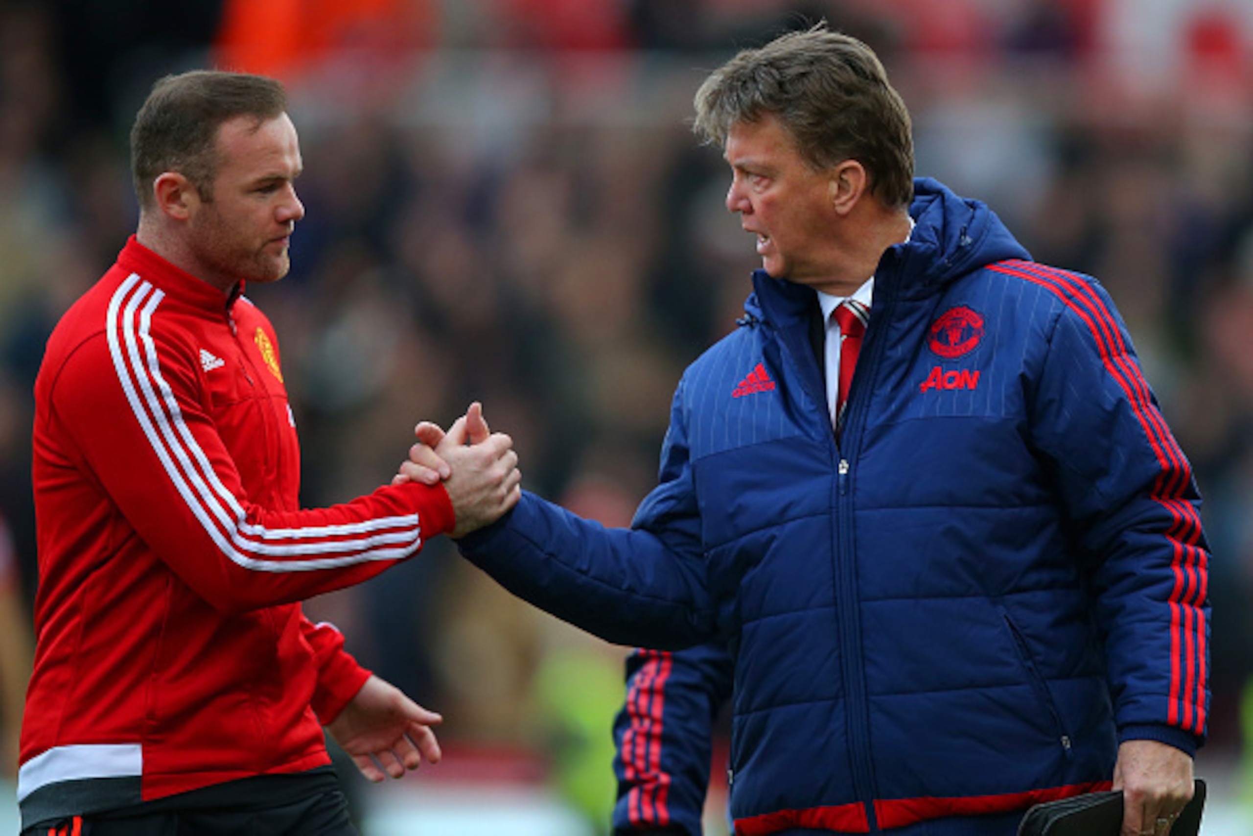 STOKE ON TRENT, ENGLAND - DECEMBER 26:  Louis van Gaal, manager of Manchester United shakes hands with Wayne Rooney of Manchester United during the Barclays Premier League match between Stoke City and Manchester United at Britannia Stadium on December 26,