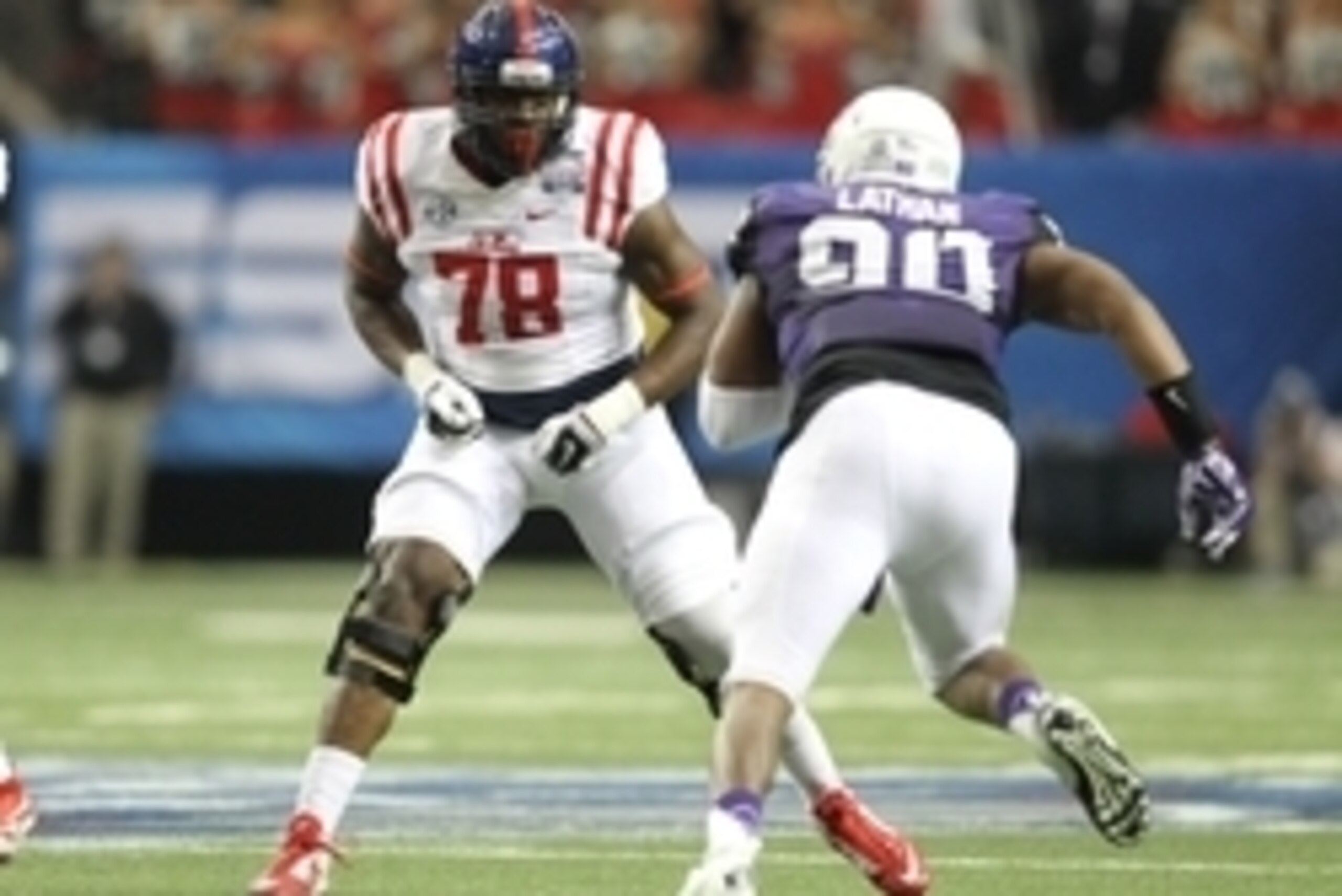 Dec 31, 2014; Atlanta , GA, USA; Mississippi Rebels offensive lineman Laremy Tunsil (78) prepares to block TCU Horned Frogs defensive tackle Terrell Lathan (90) during the first quarter in the 2014 Peach Bowl at the Georgia Dome. Mandatory Credit: Brett D