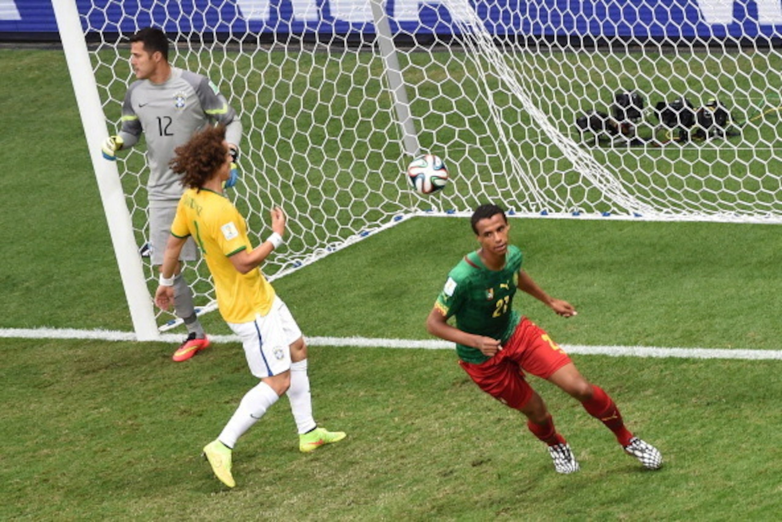 Cameroon's midfielder Joel Matip (R) celebrates after scoring a goal as Brazil's defender David Luiz (C) and Brazil's goalkeeper Julio Cesar react during the Group A football match between Cameroon and Brazil at the Mane Garrincha National Stadium in Bras
