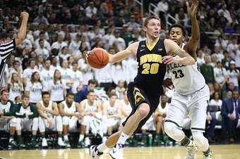 EAST LANSING, MI - JANUARY  14: Jarrod Uthoff #20 of the Iowa Hawkeyes drives to the basket  and fouled by Deyonta Davis #23 of the Michigan State Spartans in the first half at the Breslin Center on January 14, 2016 in East Lansing, Michigan. (Photo by Re
