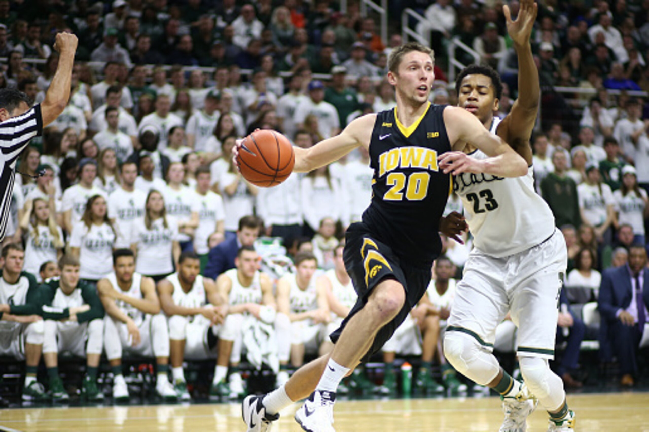 EAST LANSING, MI - JANUARY  14: Jarrod Uthoff #20 of the Iowa Hawkeyes drives to the basket  and fouled by Deyonta Davis #23 of the Michigan State Spartans in the first half at the Breslin Center on January 14, 2016 in East Lansing, Michigan. (Photo by Re