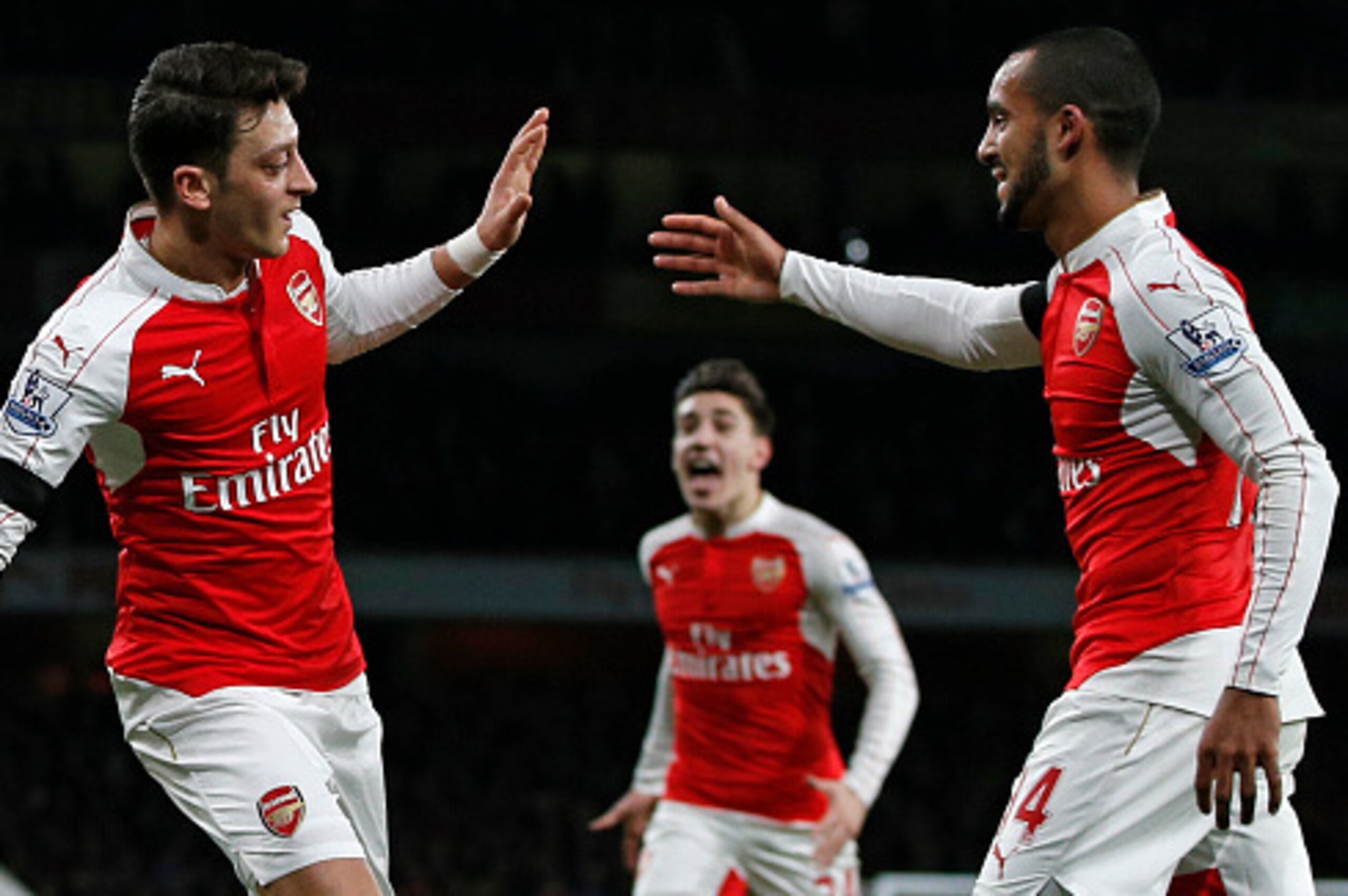 Arsenal's German midfielder Mesut Ozil (L) celebrates with Arsenal's English midfielder Theo Walcott after scoring his goal during the English Premier League football match between Arsenal and Bournemouth at the Emirates Stadium in London on December 28, Arsenal's German midfielder Mesut Ozil (L) celebrates with Arsenal's English midfielder Theo Walcott after scoring his goal during the English Premier League football match between Arsenal and Bournemouth at the Emirates Stadium in London on December 28,