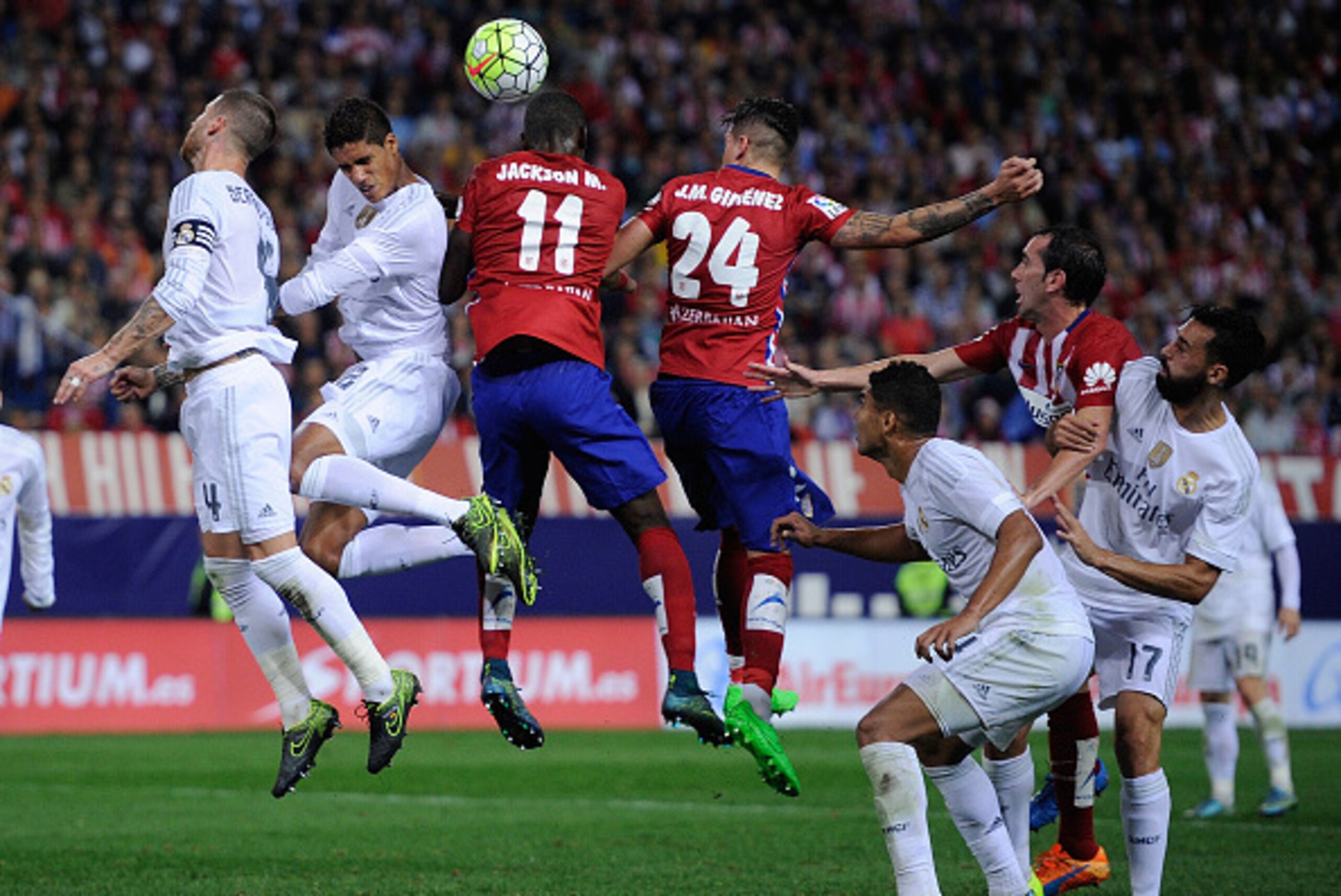 MADRID, SPAIN - OCTOBER 04:  Jackson Martinez of Club Atletico de Madrid goes for a high ball against Rafael Varane of Real Madrid during the La Liga match between Club Atletico de Madrid and Real Madrid at Vicente Calderon Stadium on October 4, 2015 in M