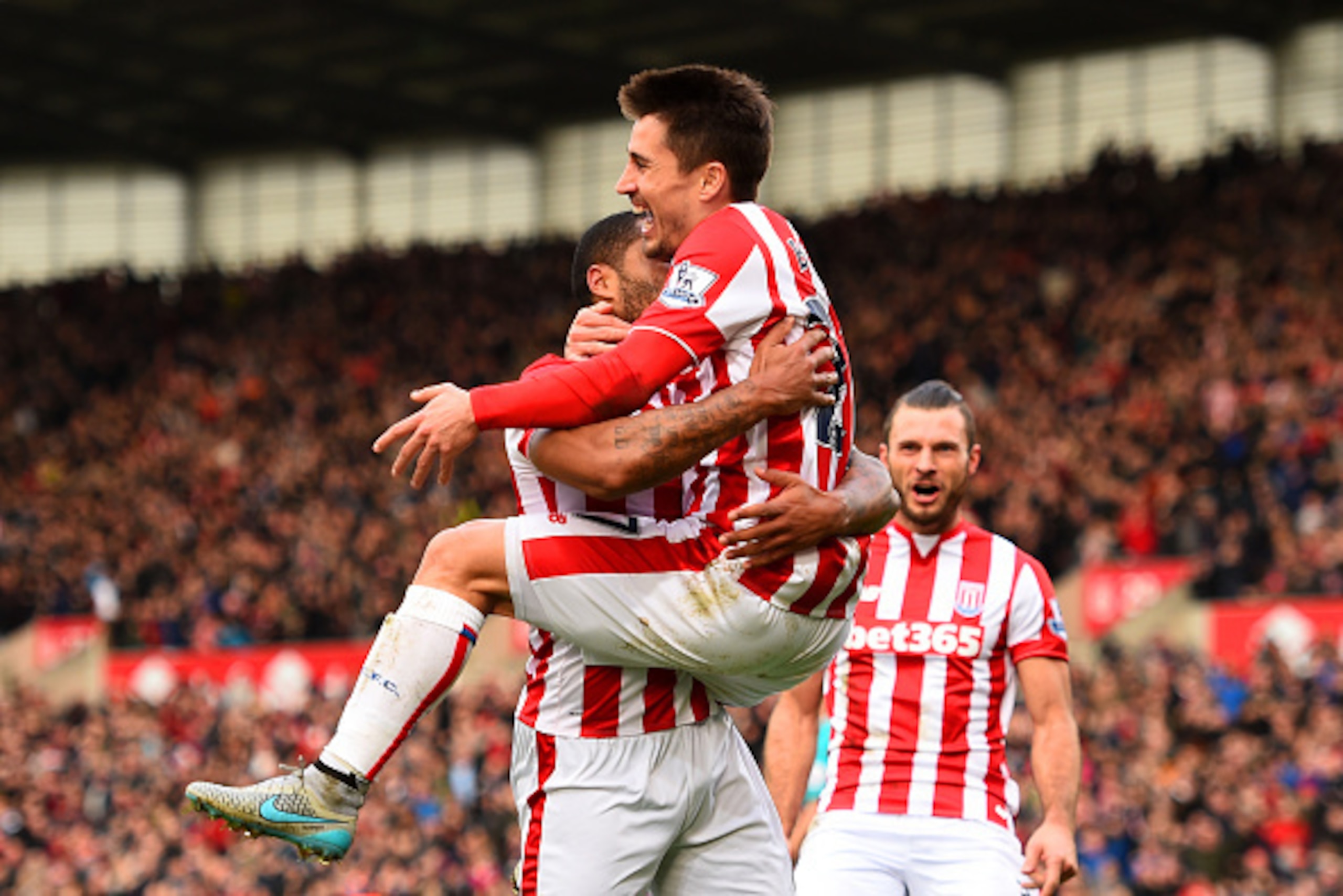 STOKE ON TRENT, ENGLAND - DECEMBER 26:  Bojan Krkic of Stoke City celebrates with team-mates, including Marko Arnautovic of Stoke City, after scoring the opening goal during the Barclays Premier League match between Stoke City and Manchester United at Bri