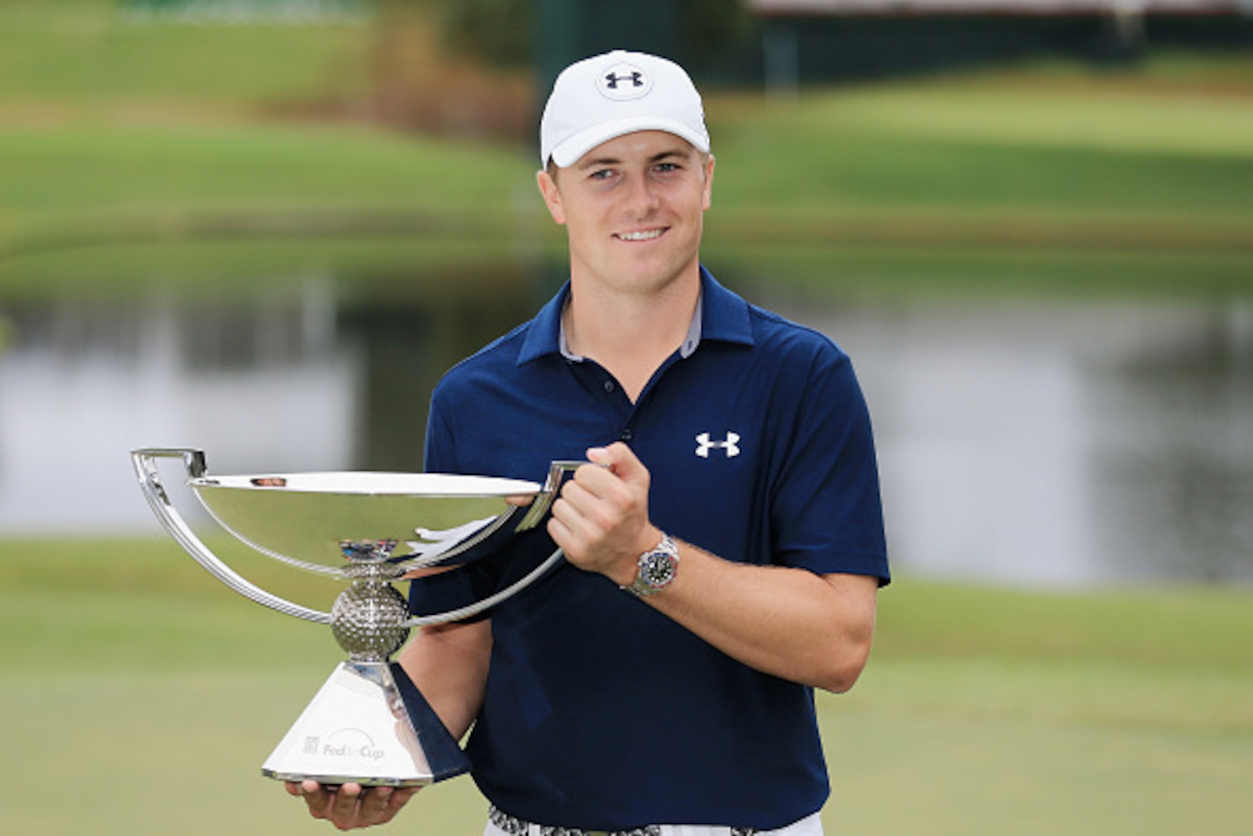 ATLANTA, GA - SEPTEMBER 27:  Jordan Spieth of the United States poses on the 18th green after winning both the TOUR Championship By Coca-Cola and the FedExCup at East Lake Golf Club on September 27, 2015 in Atlanta, Georgia  (Photo by Sam Greenwood/Getty 