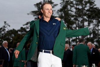 AUGUSTA, GA - APRIL 12:  Jordan Spieth of the United States is presented with his Green Jacket after the final round of the 2015 Masters at Augusta National Golf Club on April 12, 2015 in Augusta, Georgia.  (Photo by Ross Kinnaird/Getty Images)