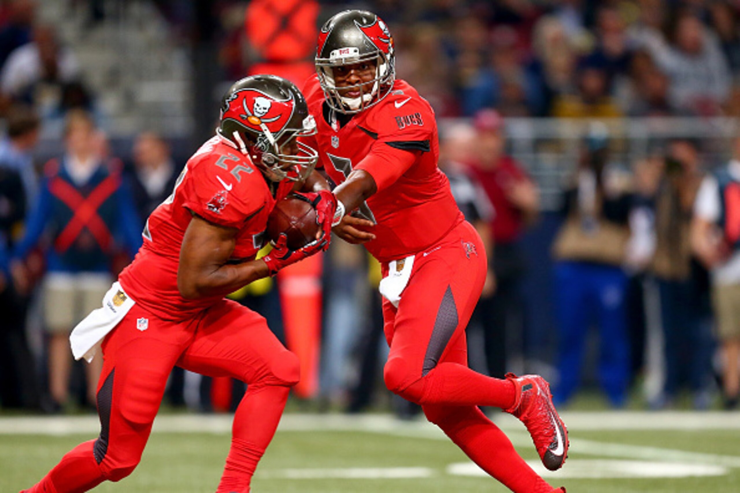 ST. LOUIS, MO - DECEMBER 17: Jameis Winston #3 of the Tampa Bay Buccaneers hands off the ball to Doug Martin #22 in the first quarter against the St. Louis Rams at the Edward Jones Dome on December 17, 2015 in St. Louis, Missouri. (Photo by Dilip Vishwana
