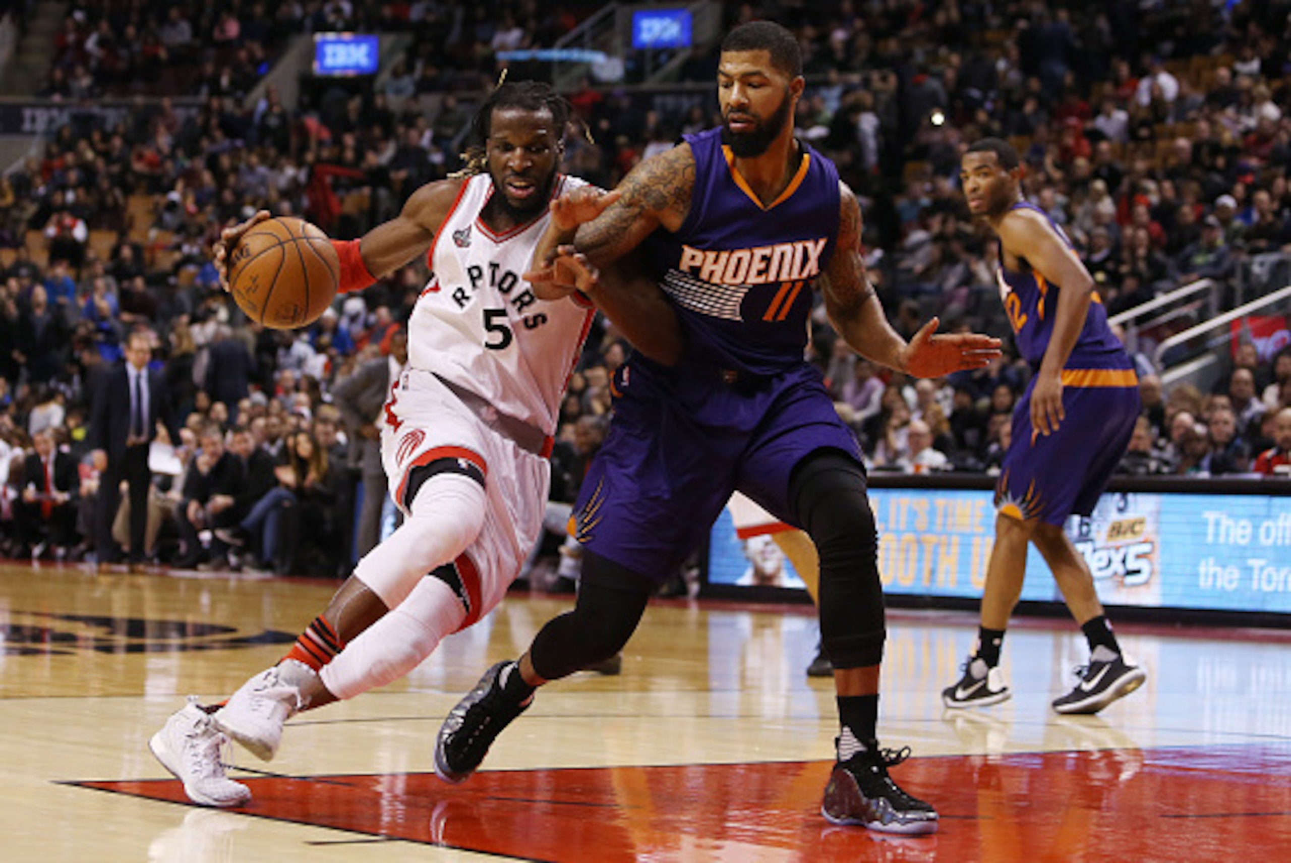 TORONTO, ON - NOVEMBER 29:  DeMarre Carroll #5 of the Toronto Raptors battles with Markieff Morris #11 of the Phoenix Suns during an NBA game at the Air Canada Centre on November 29, 2015 in Toronto, Ontario, Canada.  NOTE TO USER: User expressly acknowle