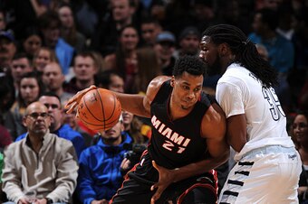 DENVER, CO - JANUARY 15:  Hassan Whiteside #21 of the Miami Heat handles the ball against Kenneth Faried #35 of the Denver Nuggets on January 15, 2016 at the Pepsi Center in Denver, Colorado. NOTE TO USER: User expressly acknowledges and agrees that, by d