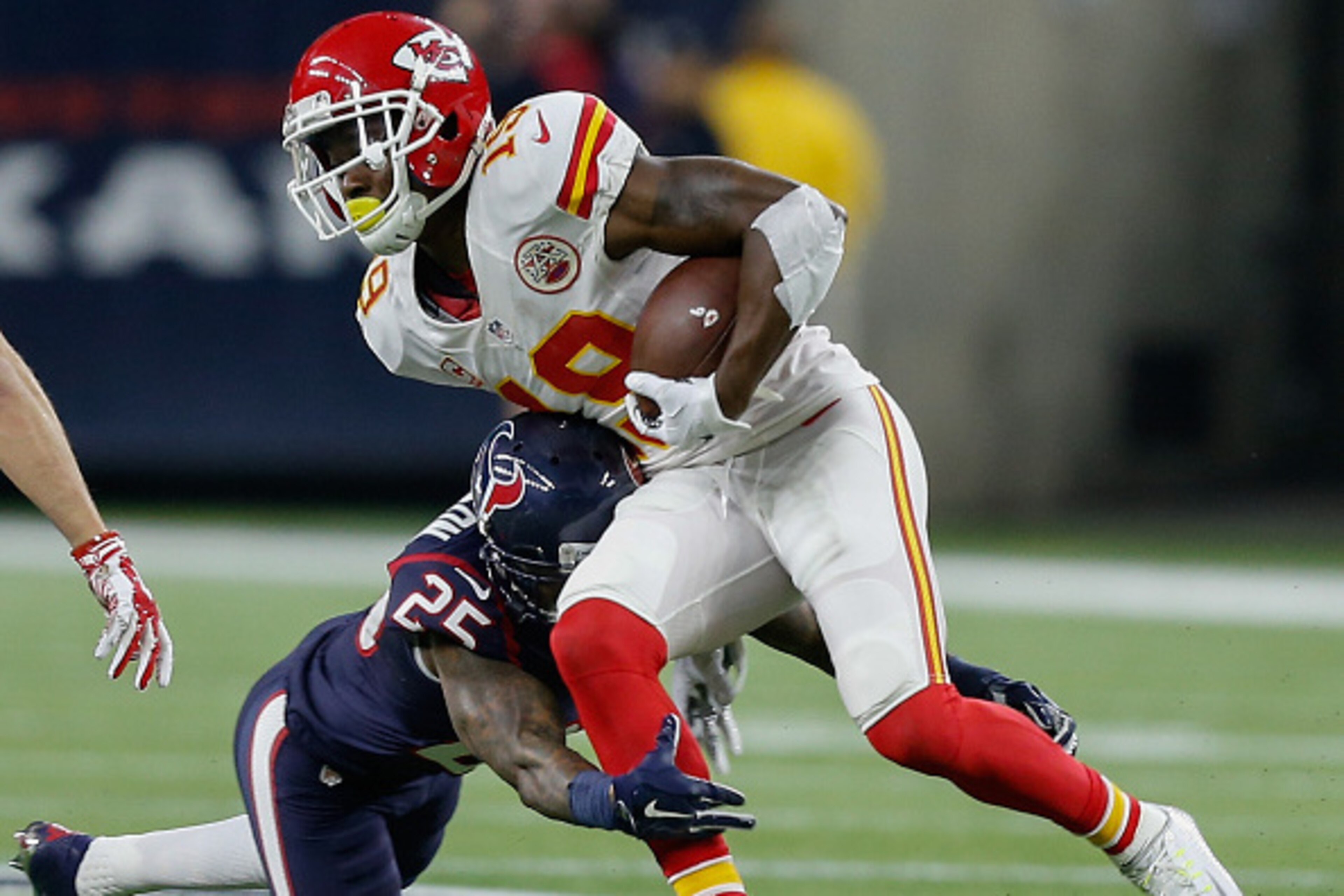 HOUSTON, TX - JANUARY 09:  Jeremy Maclin #19 of the Kansas City Chiefs is tackled by Kareem Jackson #25 of the Houston Texans during the AFC Wild Card game at NRG Stadium on January 9, 2016 in Houston, Texas.  (Photo by Bob Levey/Getty Images)