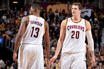 CLEVELAND, OH - NOVEMBER 28: Tristan Thompson #13 and Timofey Mozgov #20 of the Cleveland Cavaliers high five each other during the game against the Brooklyn Nets on November 28, 2015 at Quicken Loans Arena in Cleveland, Ohio.  NOTE TO USER: User expressl