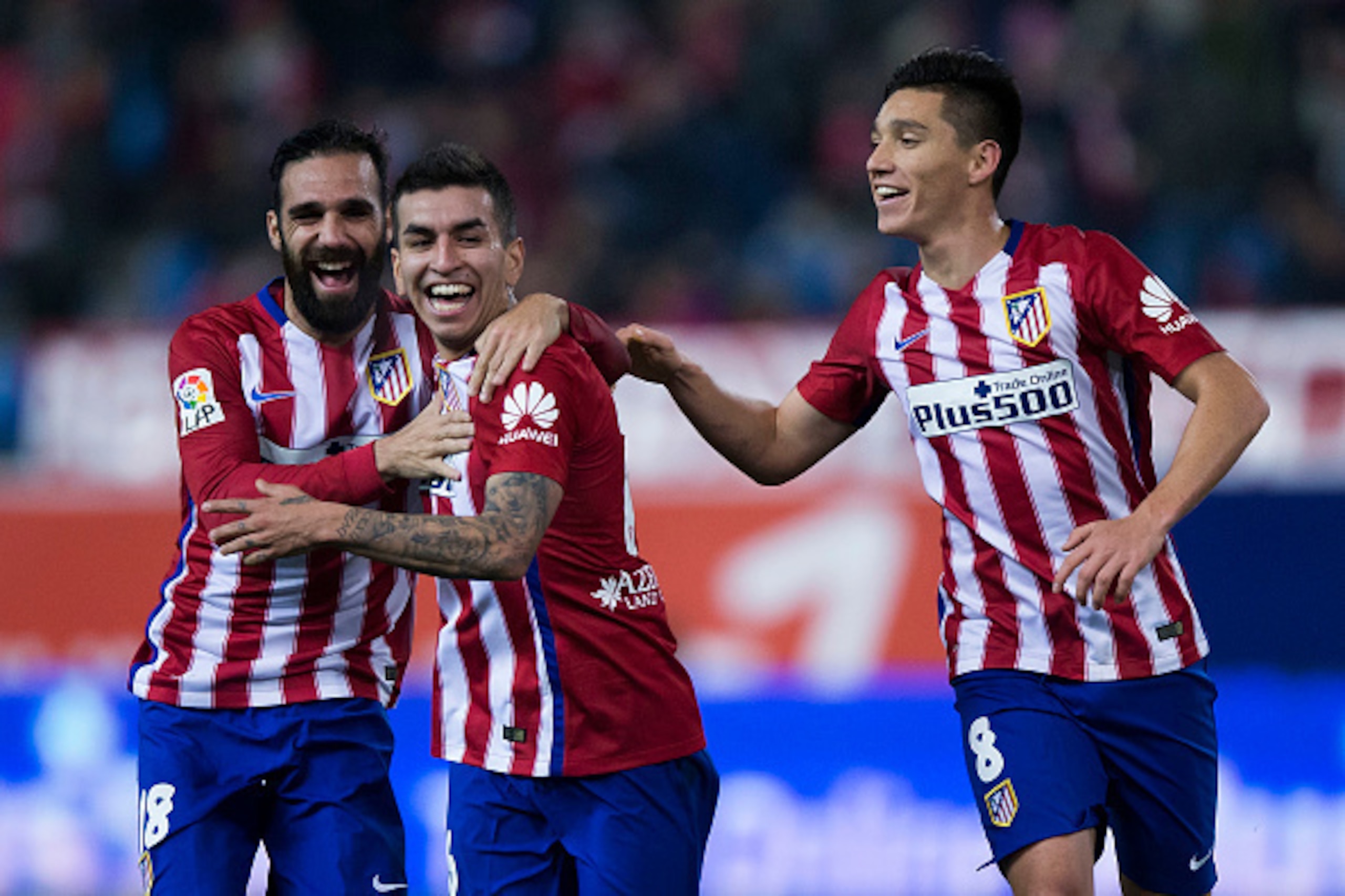 MADRID, SPAIN - JANUARY 14:  Angel Martin Correa (2ndL) of Atletico de Madrid celebrates scoring their opening goal with teammates Jesus Gamez (L) and Matias Kranevitter (R) during the Copa del Rey Round of 16 second leg match between Club Atletico Madrid