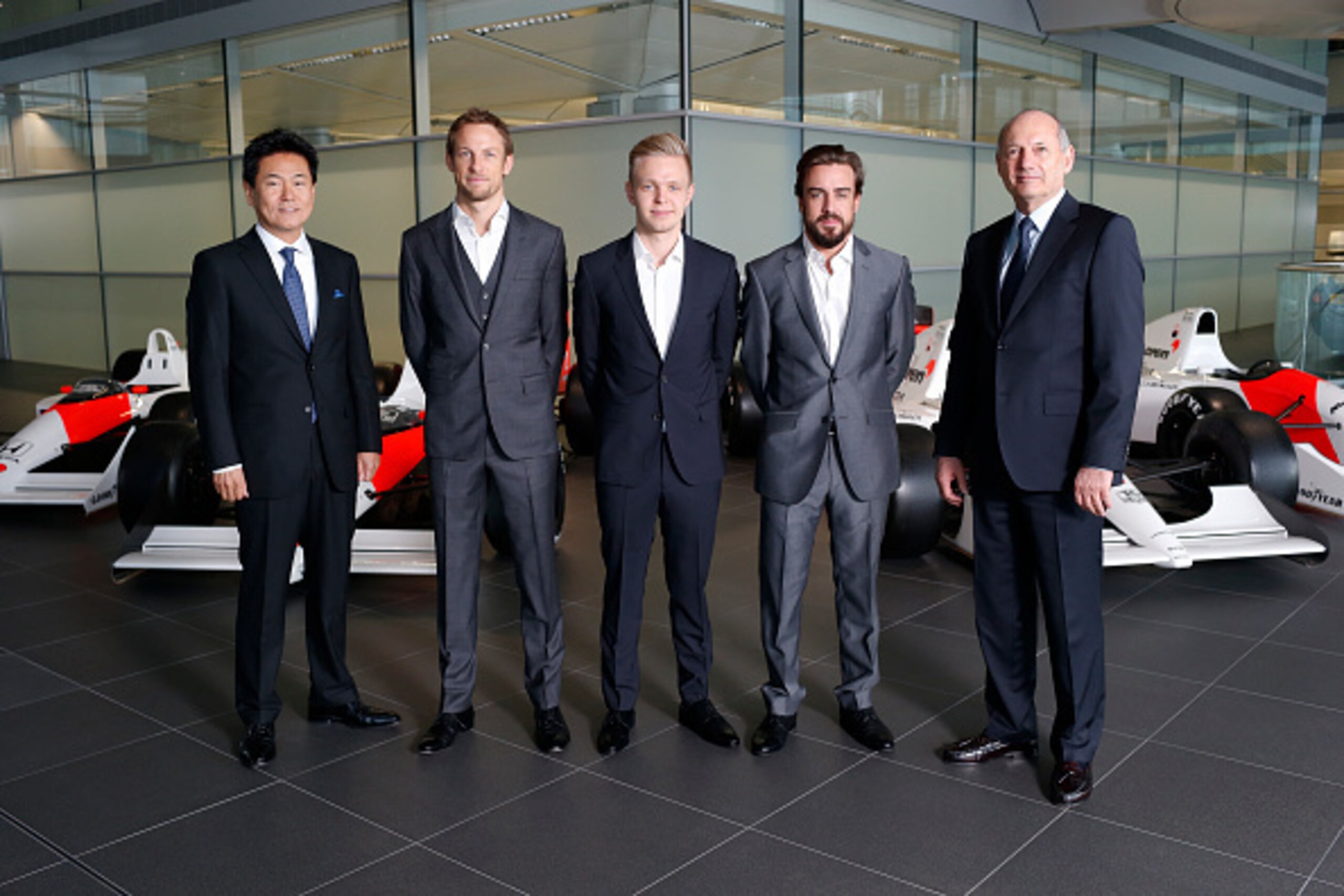 WOKING, ENGLAND- DECEMBER 10: In this handout photo provided by McLaren-Honda, Formula One drivers Fernando Alonso (2nd R) and Jenson Button (2nd L) pose as McLaren-Honda announces its new driver line-up for 2015 with Kevin Magnussen (C) who will remain a