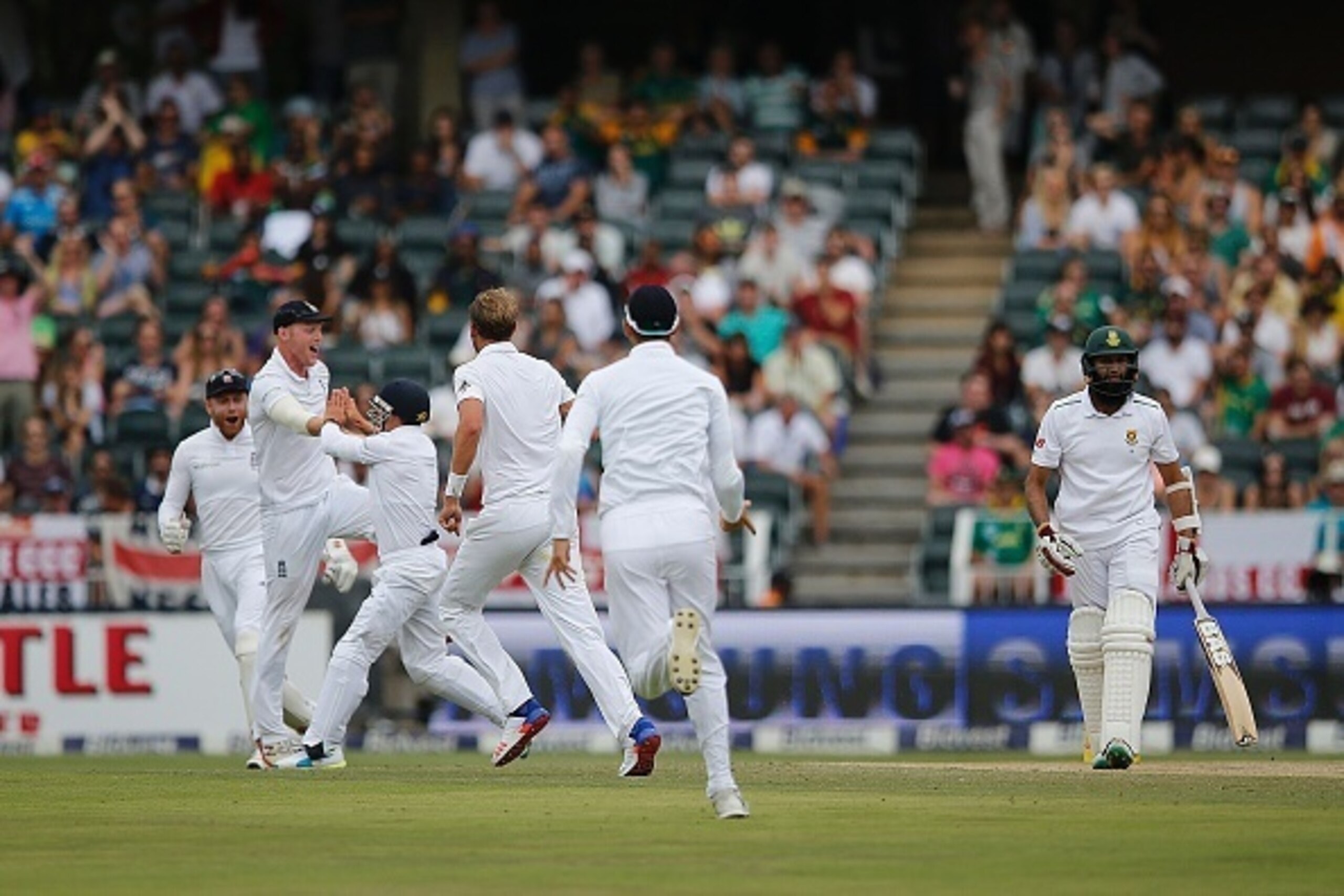 South Africa batsman Hashim Amla is caught out by England fielder James Taylor during day three of the third Test match between South Africa and England at Wanderers Stadium in Johannesburg, on January 16,  2016. / AFP / MARCO LONGARI        (Photo credit