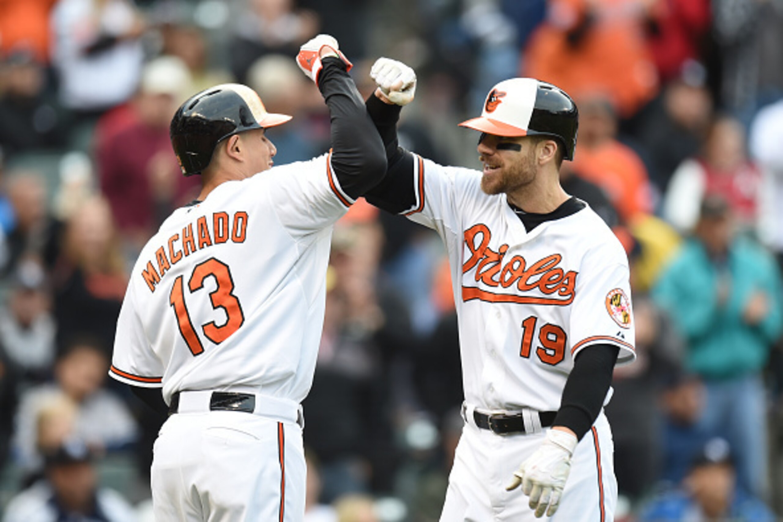 BALTIMORE, MD - OCTOBER 04:  Manny Machado #13 of the Baltimore Orioles congradulates Chris Davis #19 on a home run during a baseball game against the New York Yankees at Oriole Park at Camden Yards on October 4, 2015 in Baltimore, Maryland.  The Orioles 