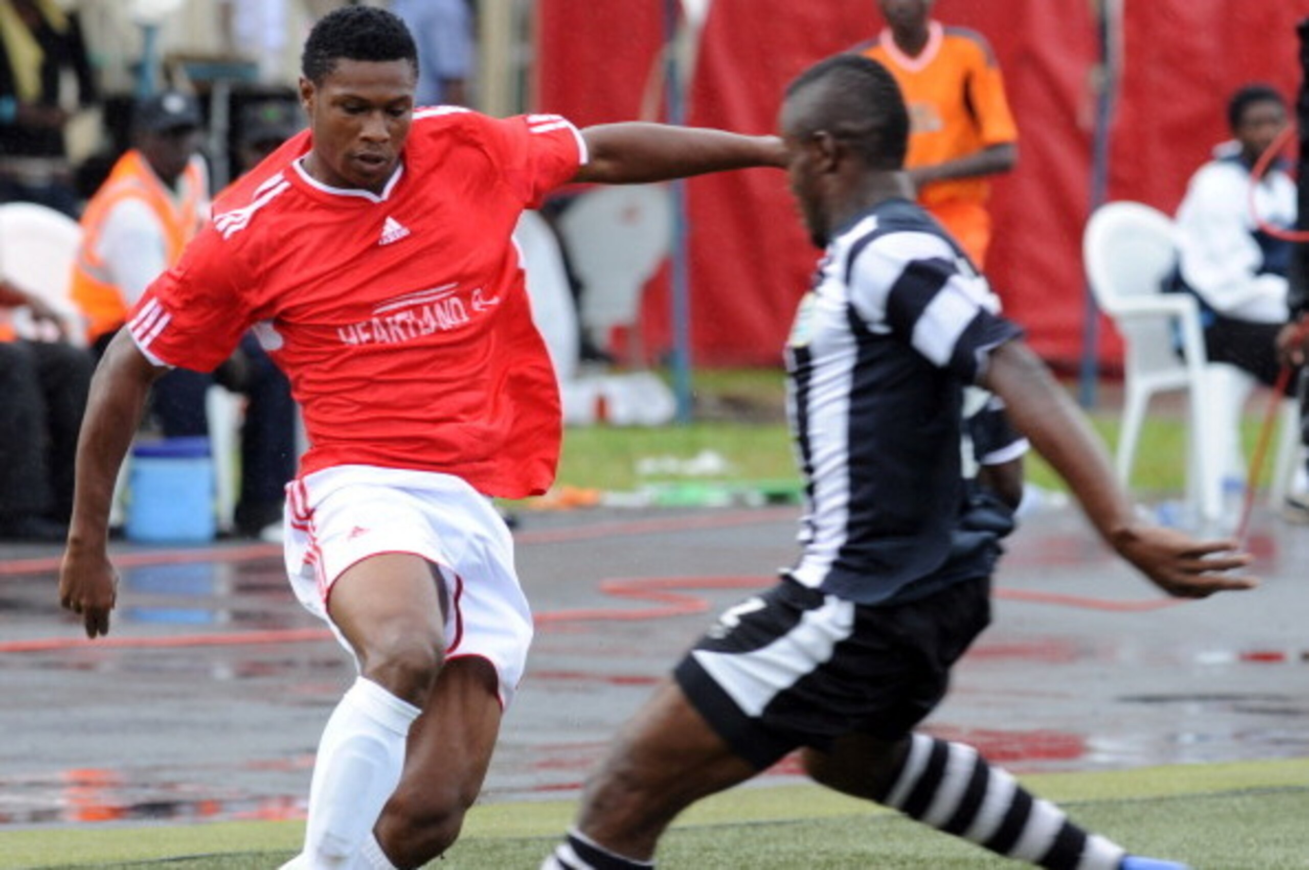 Heartland's attacker Kalu Orji (L) vies with Lobi Stars' defender Ezekiel Bassey  during the Federation Cup final in Lagos on August 26, 2012. Heartland of Owerri will again represent Nigeria in next year's CAF Confederation Cup after they defeated Lobi S