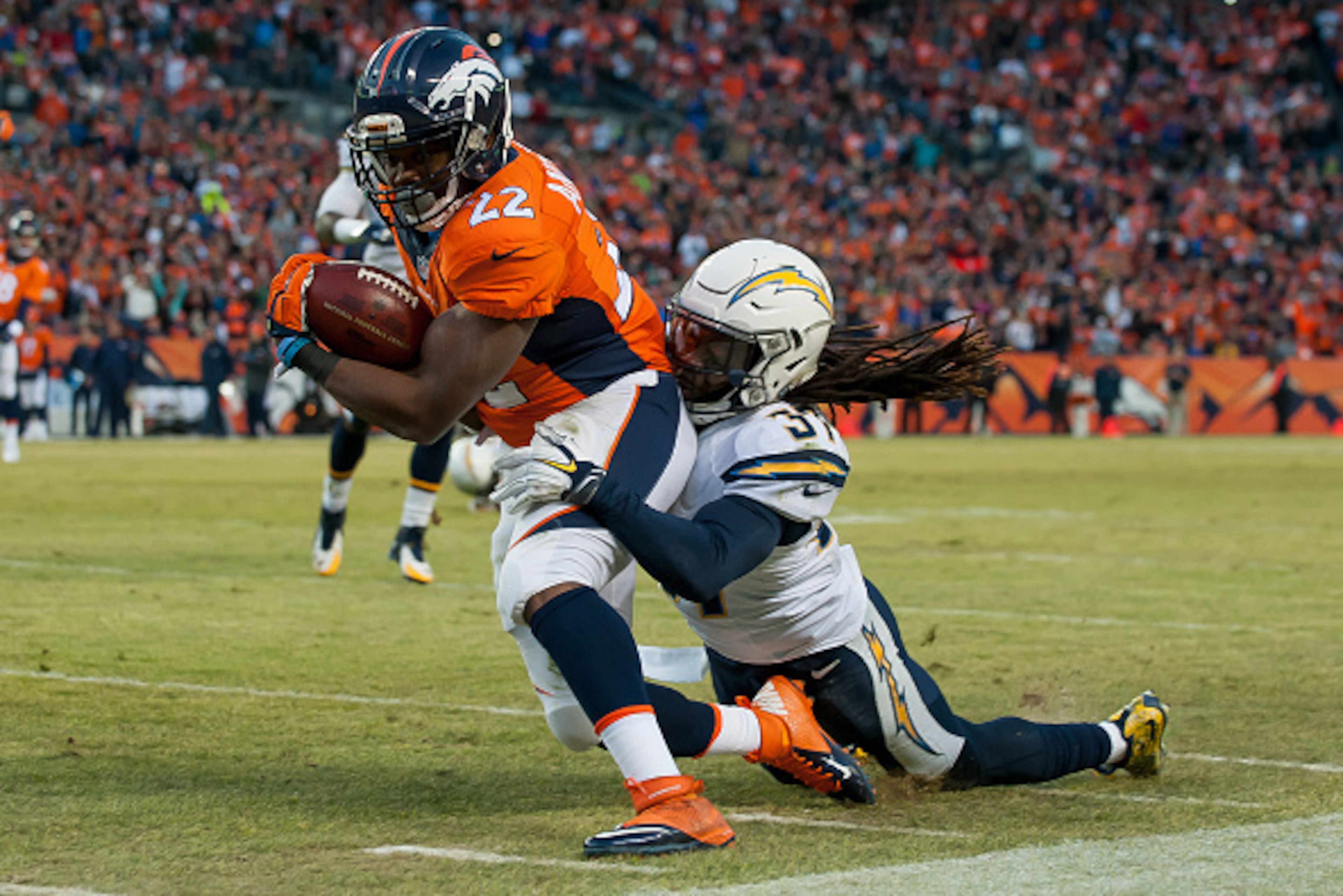 DENVER, CO - JANUARY 3: Running back C.J. Anderson #22 of the Denver Broncos is tackled by strong safety Jahleel Addae #37 of the San Diego Chargers as he rushes for a first down in the third quarter of a game at Sports Authority Field at Mile High on Ja DENVER, CO - JANUARY 3: Running back C.J. Anderson #22 of the Denver Broncos is tackled by strong safety Jahleel Addae #37 of the San Diego Chargers as he rushes for a first down in the third quarter of a game at Sports Authority Field at Mile High on Ja