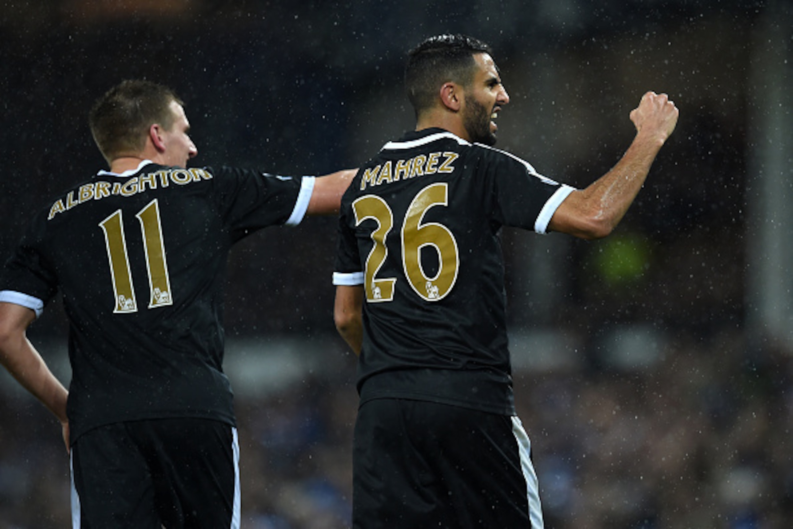 Leicester City's Algerian midfielder Riyad Mahrez (R) celebrates after scoring his and Leicester's second goal from the penalty spot during the English Premier League football match between Everton and Leicester City at Goodison Park in Liverpool, north w