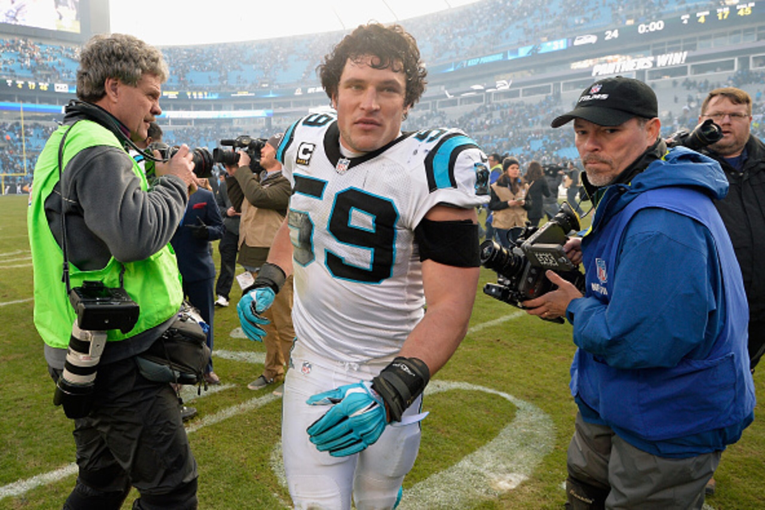 CHARLOTTE, NC - JANUARY 17:   Luke Kuechly #59 of the Carolina Panthers leaves the field after their 31-24 victory over the Seattle Seahawks at the NFC Divisional Playoff Game at Bank of America Stadium on January 17, 2016 in Charlotte, North Carolina.  (