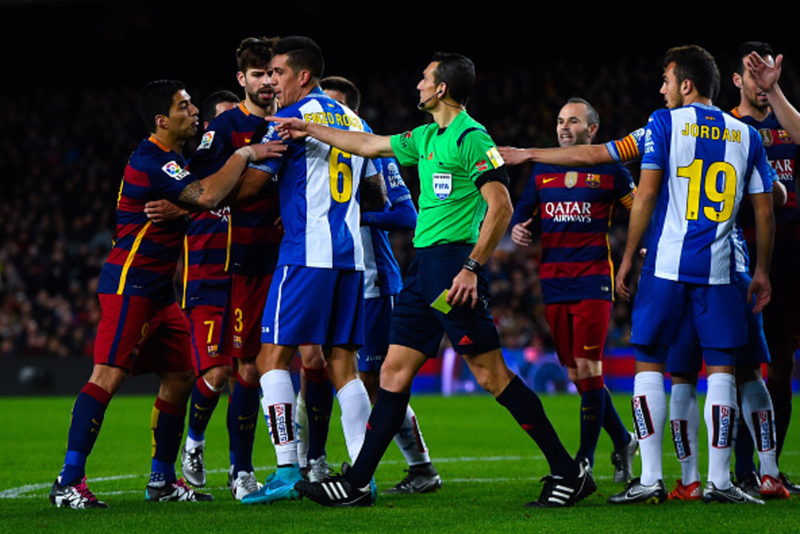 BARCELONA, SPAIN - JANUARY 06:  Luis Suarez of FC Barcelona (L) argues with RCD Espanyol players during the Copa del Rey Round of 16 first leg match between FC Barcelona and RCD Espanyol at Camp Nou on January 6, 2016 in Barcelona, Spain.  (Photo by David