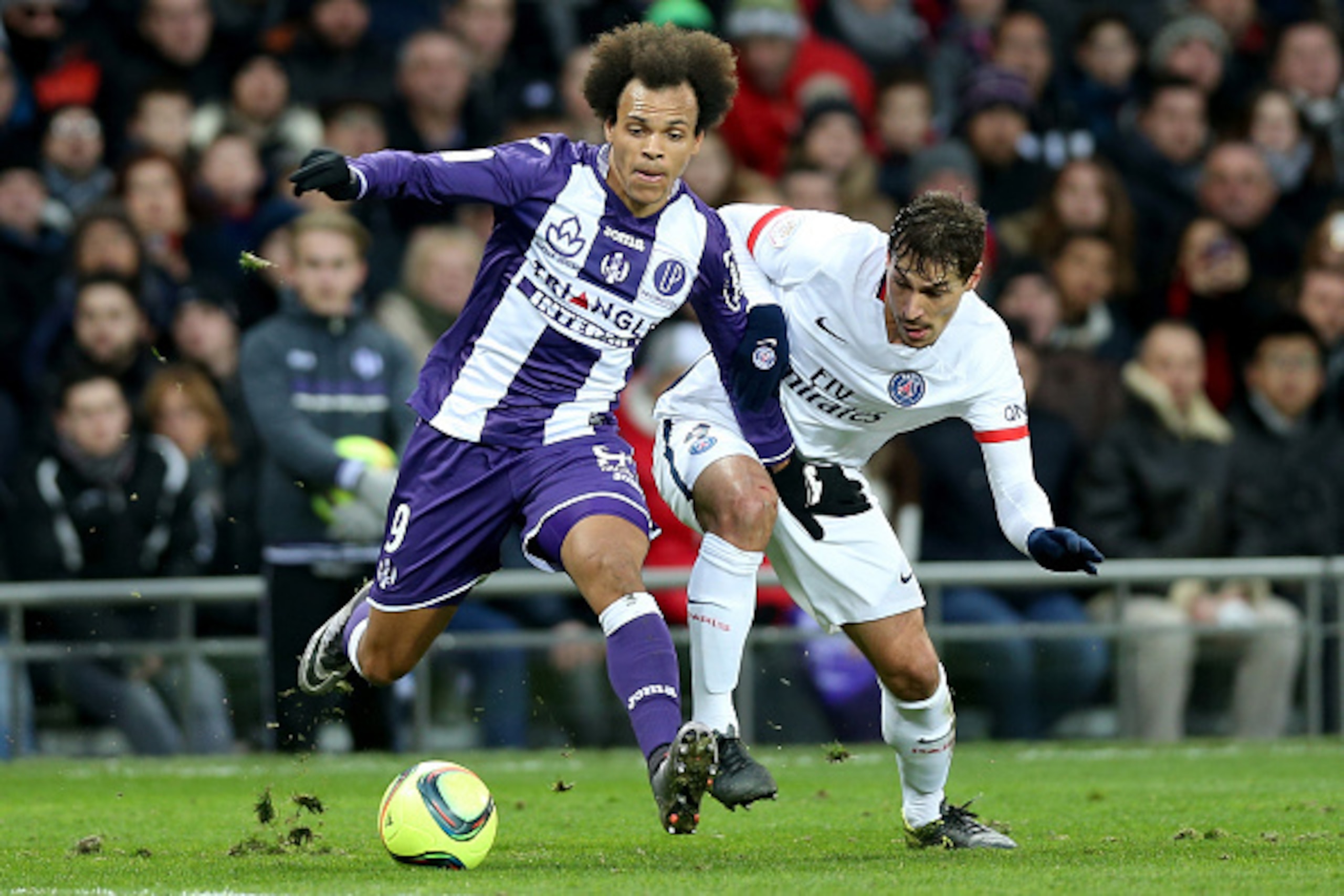 TOULOUSE, FRANCE - JANUARY 16: Martin Braithwaite for Toulouse FC and Benjamin Stambouli for Paris Saint Germain battle for the ball during the French Ligue 1 football match between Toulouse FC and Paris Saint-Germain at at Stadium Municipal on January 16