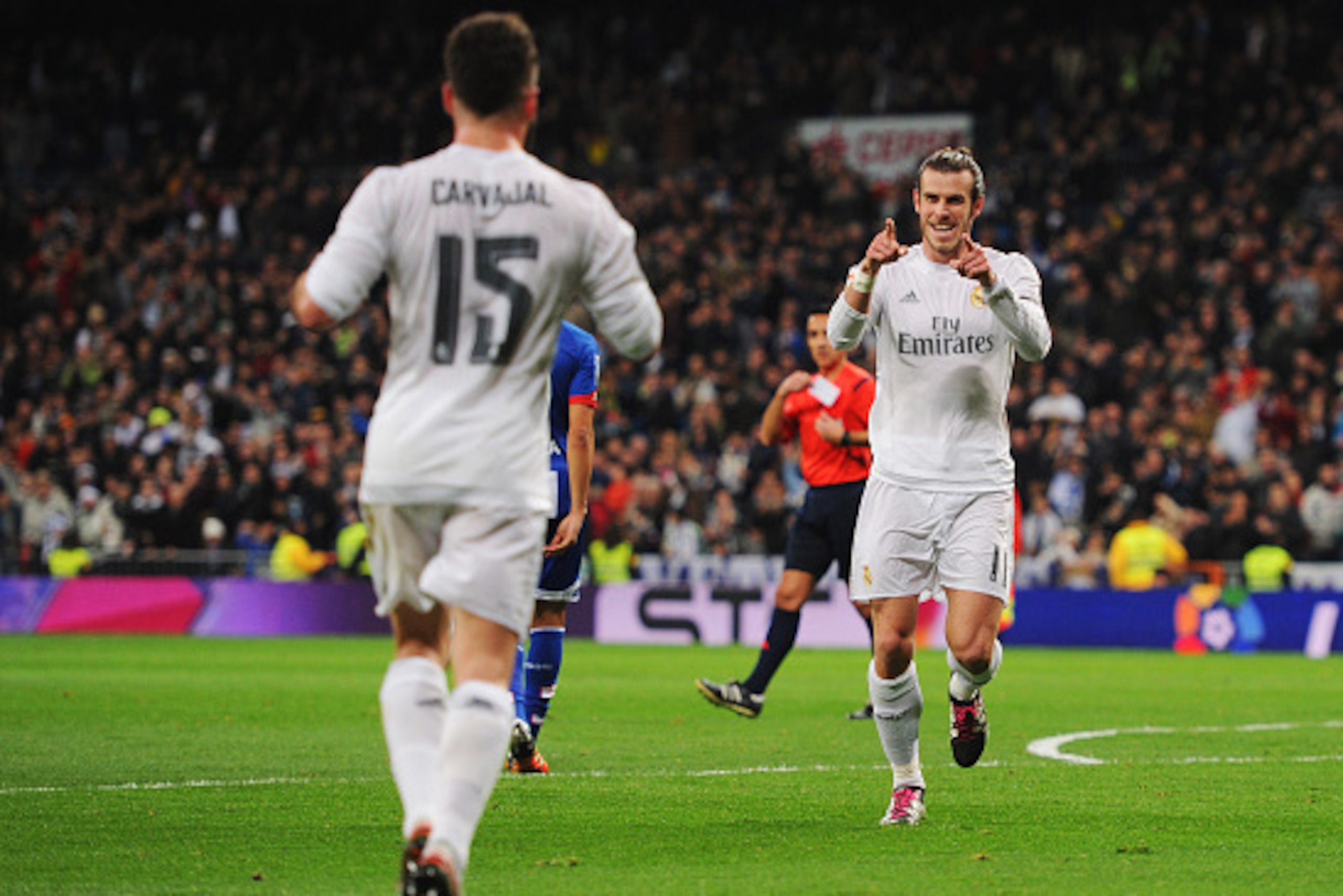 MADRID, SPAIN - JANUARY 09:  Gareth Bale of Real Madrid (R) celebrates with Daniel Carvajal as he scores their second goal during the La Liga match between Real Madrid CF and RC Deportivo La Coruna at Estadio Santiago Bernabeu on January 9, 2016 in Madrid