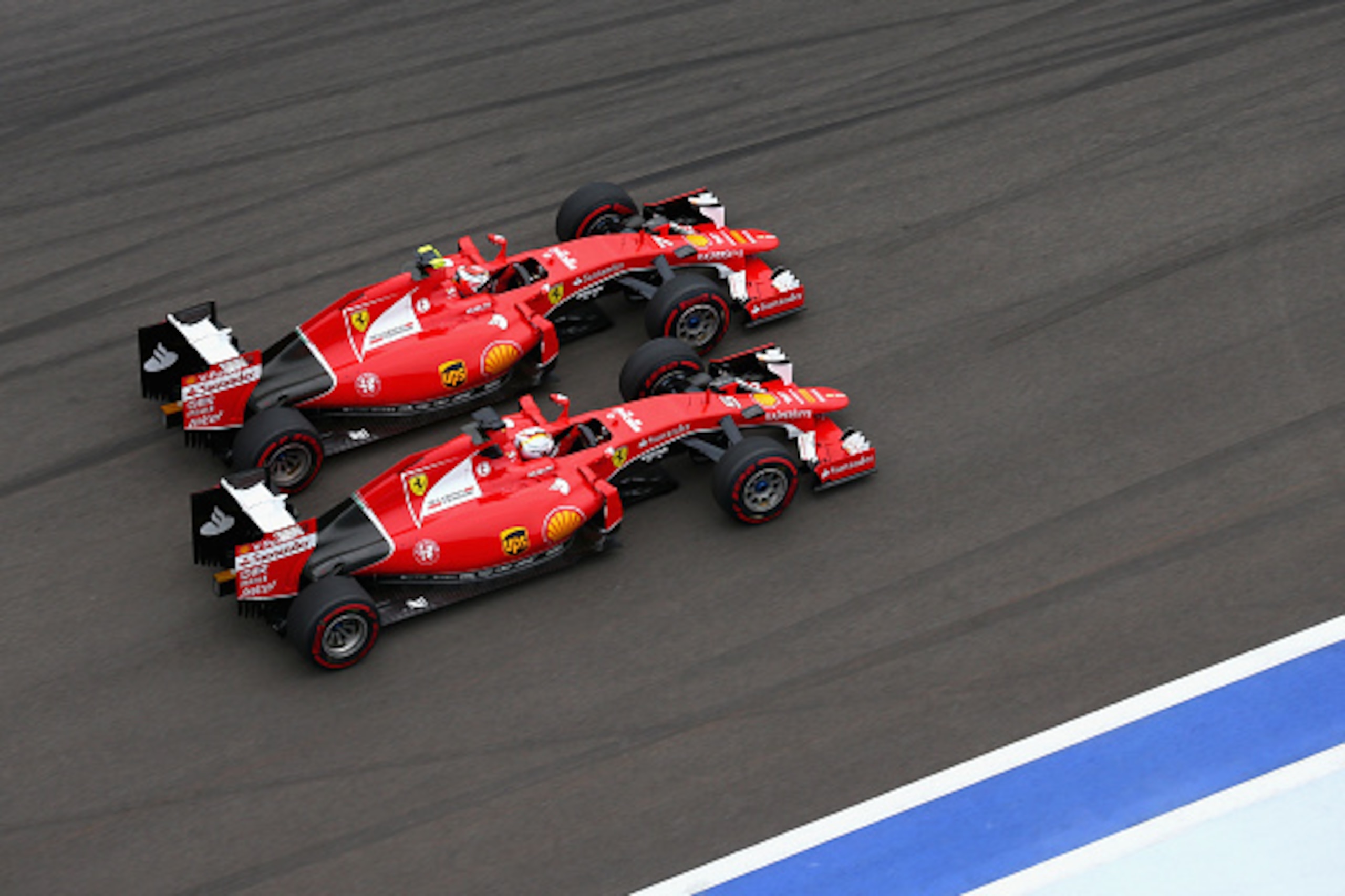 SOCHI, RUSSIA - OCTOBER 11:  Kimi Raikkonen of Finland and Ferrari and Sebastian Vettel of Germany and Ferrari race during the Formula One Grand Prix of Russia at Sochi Autodrom on October 11, 2015 in Sochi, Russia.  (Photo by Clive Mason/Getty Images)