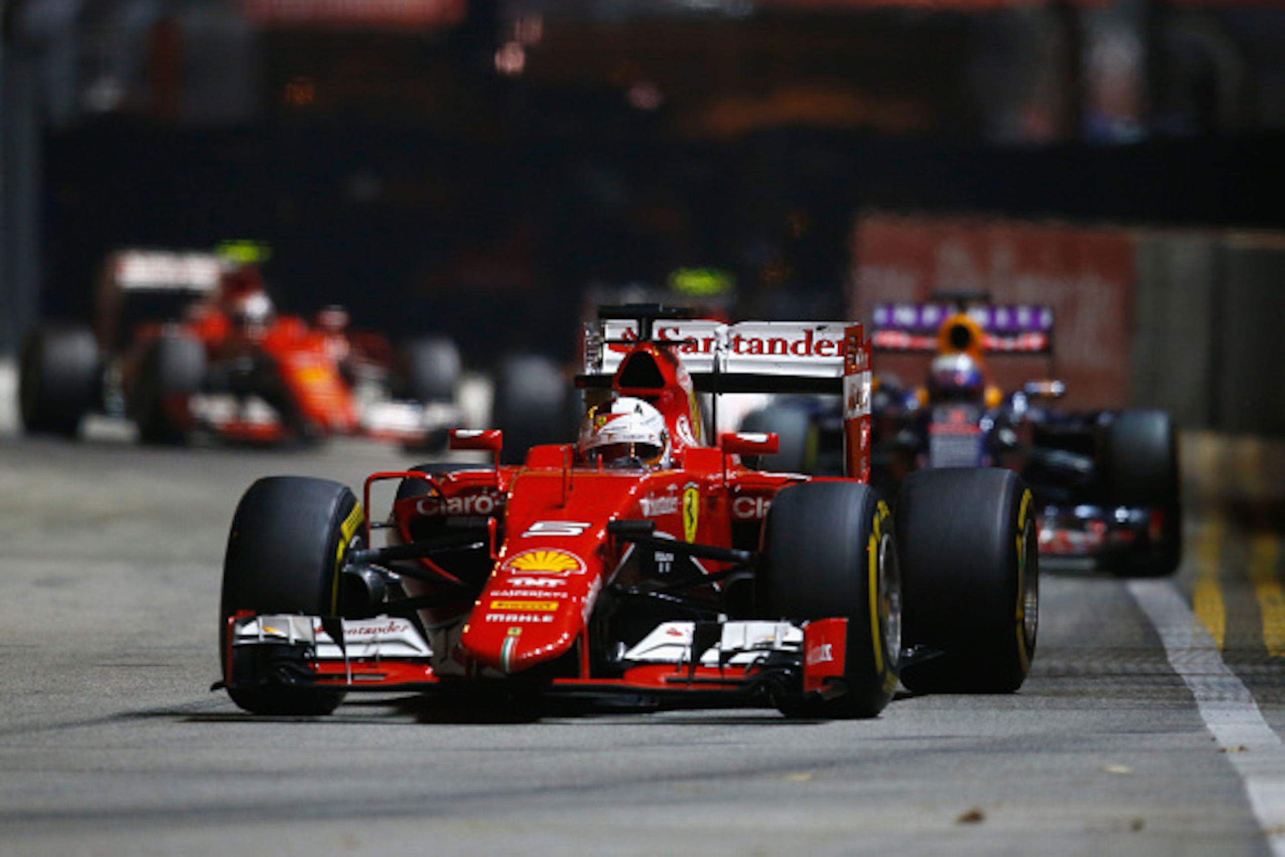 SINGAPORE - SEPTEMBER 20:  Sebastian Vettel of Germany and Ferrari drives during the Formula One Grand Prix of Singapore at Marina Bay Street Circuit on September 20, 2015 in Singapore.  (Photo by Clive Rose/Getty Images)