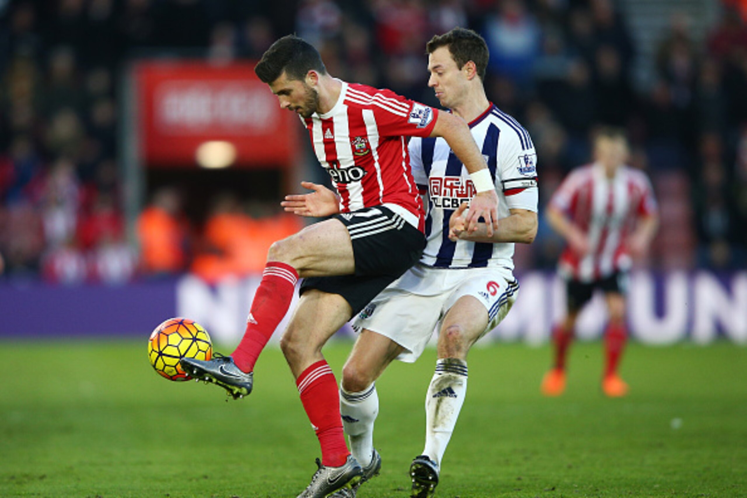 SOUTHAMPTON, ENGLAND - JANUARY 16: Shane Long of Southampton and Jonny Evans of West Bromwich Albion compete for the ball during the Barclays Premier League match between Southampton and West Bromwich Albion at St. Mary's Stadium on January 16, 2016 in So