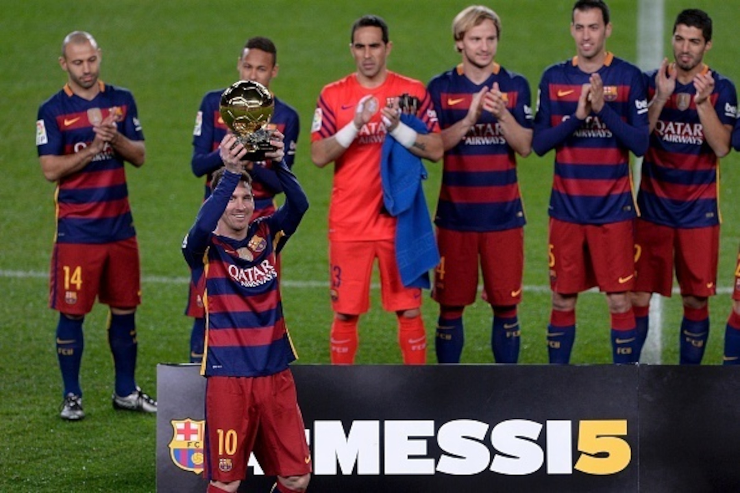 CORRECTION CREDIT IN BYLINE AND CAPTION
Barcelona's Argentinian forward Lionel Messi (2ndL) poses with teammates and his fifth Ballon d'Or trophy before the Spanish league football match FC Barcelona vs Athletic Club Bilbao at the Camp Nou stadium in Barc