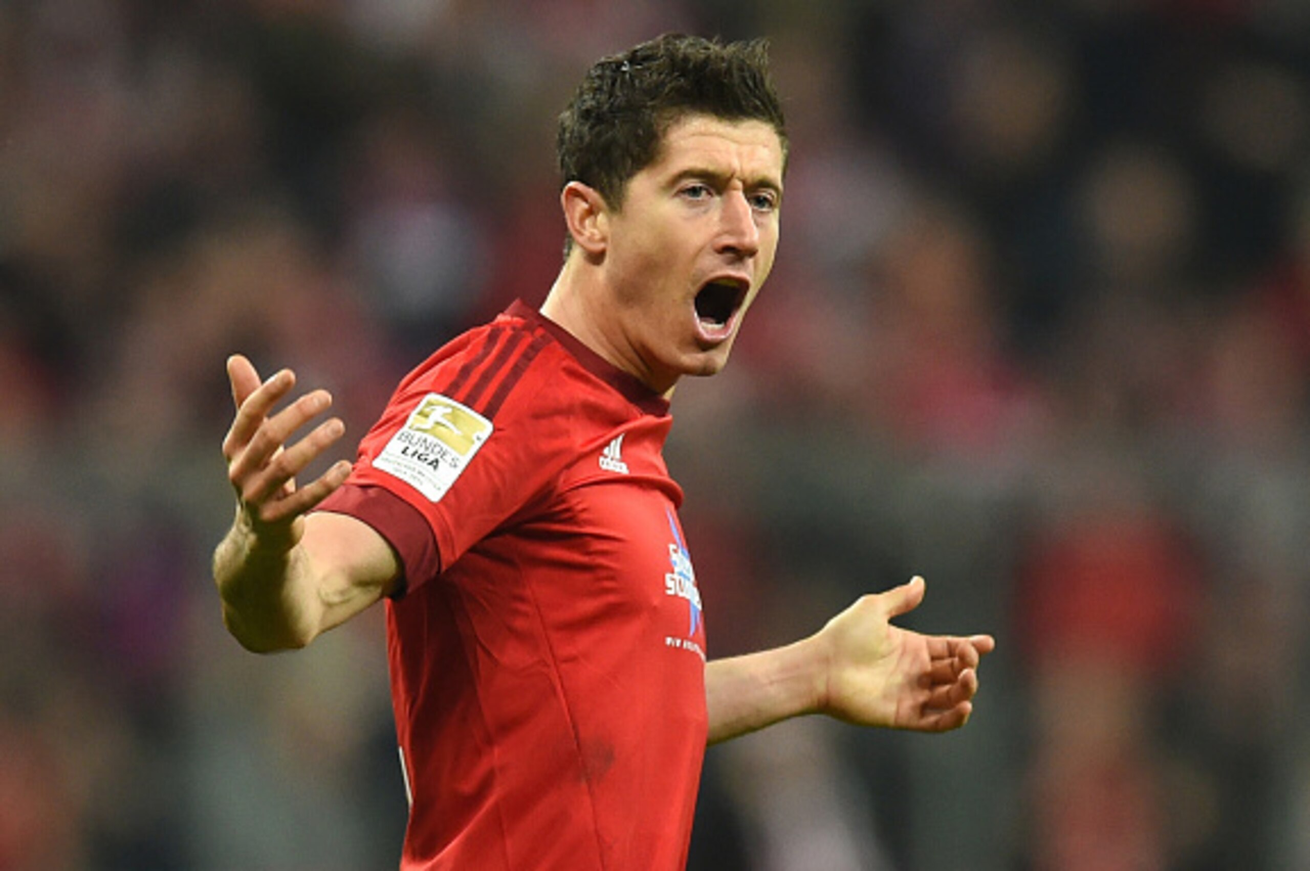 Bayern Munich's Polish striker Robert Lewandowski celebrates scoring during the German first division Bundesliga football match FC Bayern Munich vs FC Ingolstadt 04 in Munich, southern Germany, on December 12, 2015. AFP PHOTO / CHRISTOF STACHE

RESTRICTIO