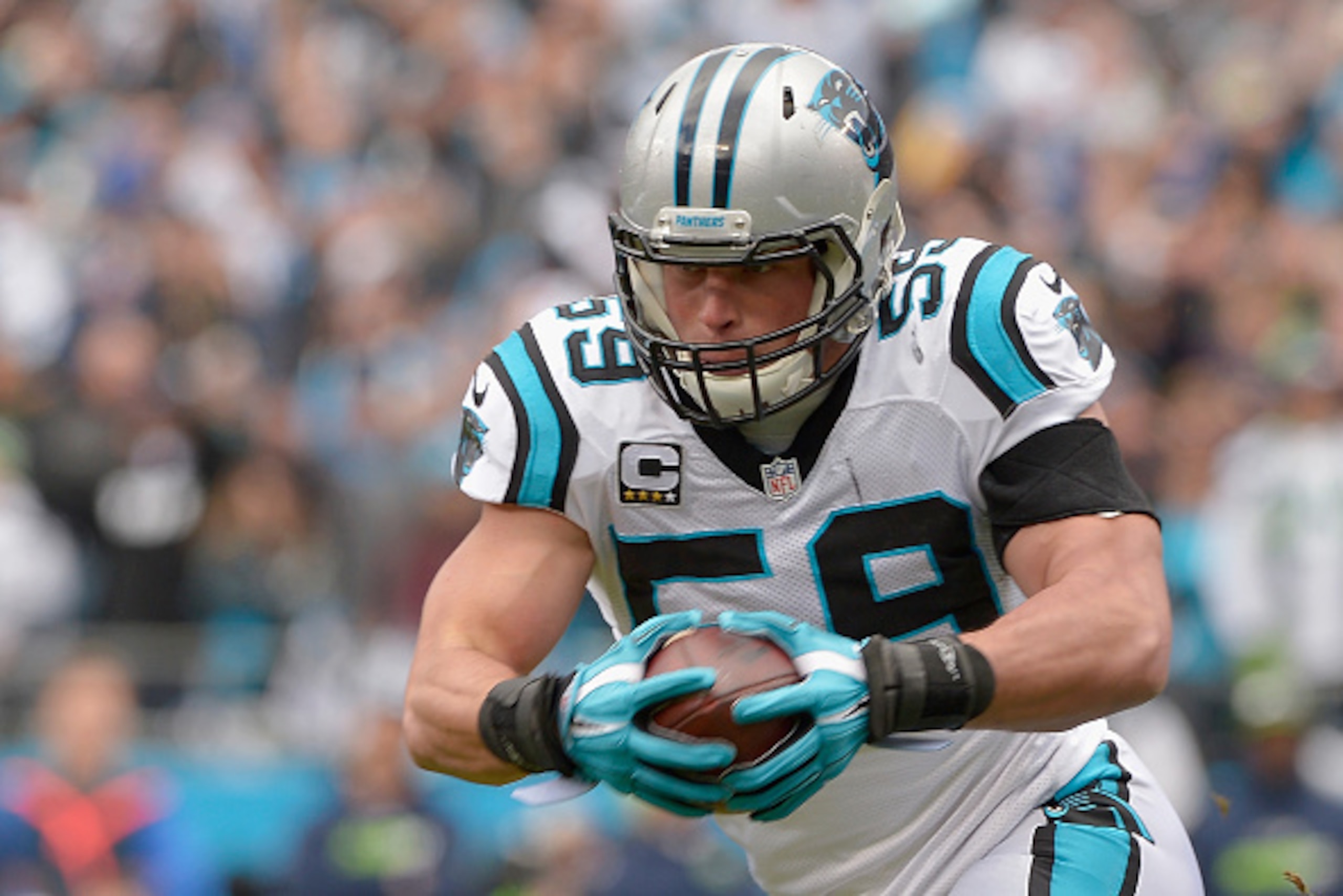 CHARLOTTE, NC - JANUARY 17:  Luke Kuechly #59 of the Carolina Panthers returns an interception for a touchdown during the first quarter of the NFC Divisional Playoff Game against the Seattle Seahawks at Bank of America Stadium on January 17, 2016 in Charl