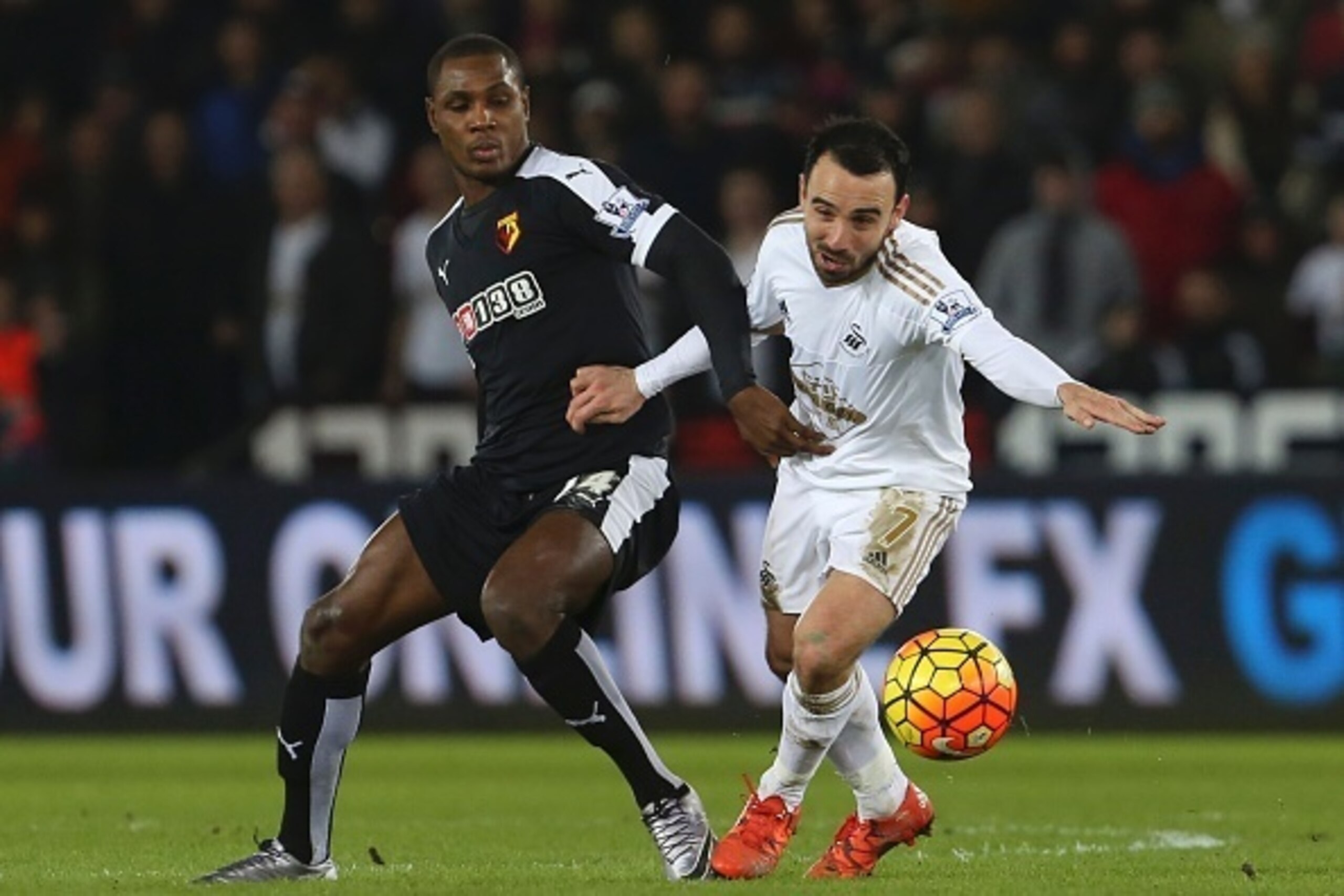 Watford's Nigerian striker Odion Ighalo (L) challenges Swansea City's English midfielder Leon Britton (R) during the English Premier League football match between Swansea City and Watford at The Liberty Stadium in Swansea, south Wales on January 18, 2016.